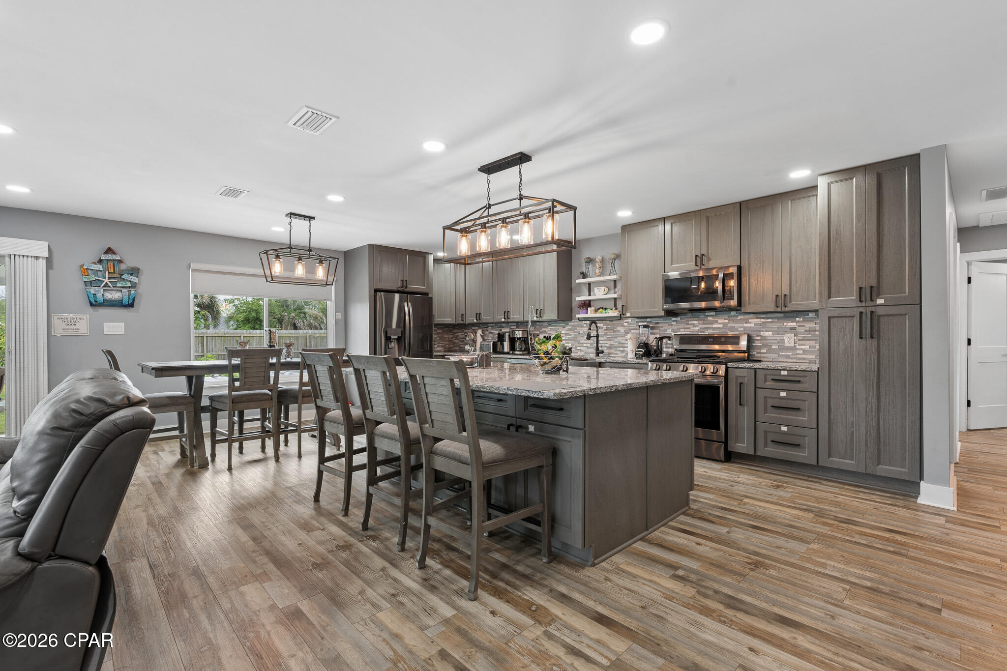 $5K toward Buyers Closing Costs!!  This beautifully updated like-new home in Callaway offers modern comfort, thoughtful upgrades, and convenient access to everything the area has to offer. Located just minutes from shopping, restaurants, and waterfront recreation, enjoy being approximately 0.4 miles from fishing charters at Pier 98, 1.4 miles to a public boat ramp, 4 miles to Tyndall Air Force Base, and about 33 miles to St. Andrews State Park.

Extensively remodeled and brought down to the studs following the hurricane, this home features updated electrical, plumbing, and gas lines for added peace of mind. Designed with efficiency and comfort in mind, upgrades include a tankless gas water heater, whole-house generator, solar panels that will be paid off at closing, impact-resistant windows, and automatic shades.

The kitchen is a standout with stainless steel appliances, gas range, quartz countertops, decorative glass backsplash, and an oversized island with ample space for entertaining, gathering, or game nights. Interior finishes include recessed lighting, updated fixtures, and luxury vinyl plank flooring throughout.

The spacious primary suite features dual closets and a spa-inspired bath complete with an open walk-in shower, jetted soaking tub, Bluetooth speaker, and smart lighting features. The guest bath has also been tastefully updated with a glass tub enclosure, quartz countertop, and decorative sink.  Transferrable termite bond with Terminix!

Exterior improvements include durable Hardie board siding and a standing seam metal roof with all roof boots resealed in 2025. Step outside to enjoy the covered patio and fully privacy-fenced backyard. A 12x20 site-built shed with insulation, electricity, and its own covered patio provides excellent flexibility for hobbies, storage, or workspace. The backyard is enhanced with fruit trees, a fire pit area, and an additional exterior outlet ready for future outdoor additions such as a hot tub.

Don't miss your opportunity to own this extensively upgraded home with modern conveniences and room to enjoy both indoors and out.  Buyer to independently verify all information, measurements, dimensions, restrictions, and any matters deemed important.