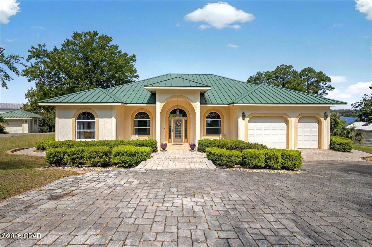 ENTERED FOR COMP PURPOSES ONLY!  240 feet of Compass Lake frontage, 1.47 acres, a beautifully designed home and more! This gorgeous home has lake views from the living areas, kitchen and bedrooms and multiple out buildings with water access points including a dock with a large gazebo, boathouse, and ski dock setting this property apart. The stunning 3 bedroom/ 2 1/2 bath house includes a 2 car garage that can be used as a playroom or 4th bedroom, 10 ft ceilings, large living area, two eating areas, and huge back porch overlooking spring fed Compass Lake. This stunning property includes a detached 2 car garage building (30x27) and shed/1 car garage (20x12) matching the finish of the main house,