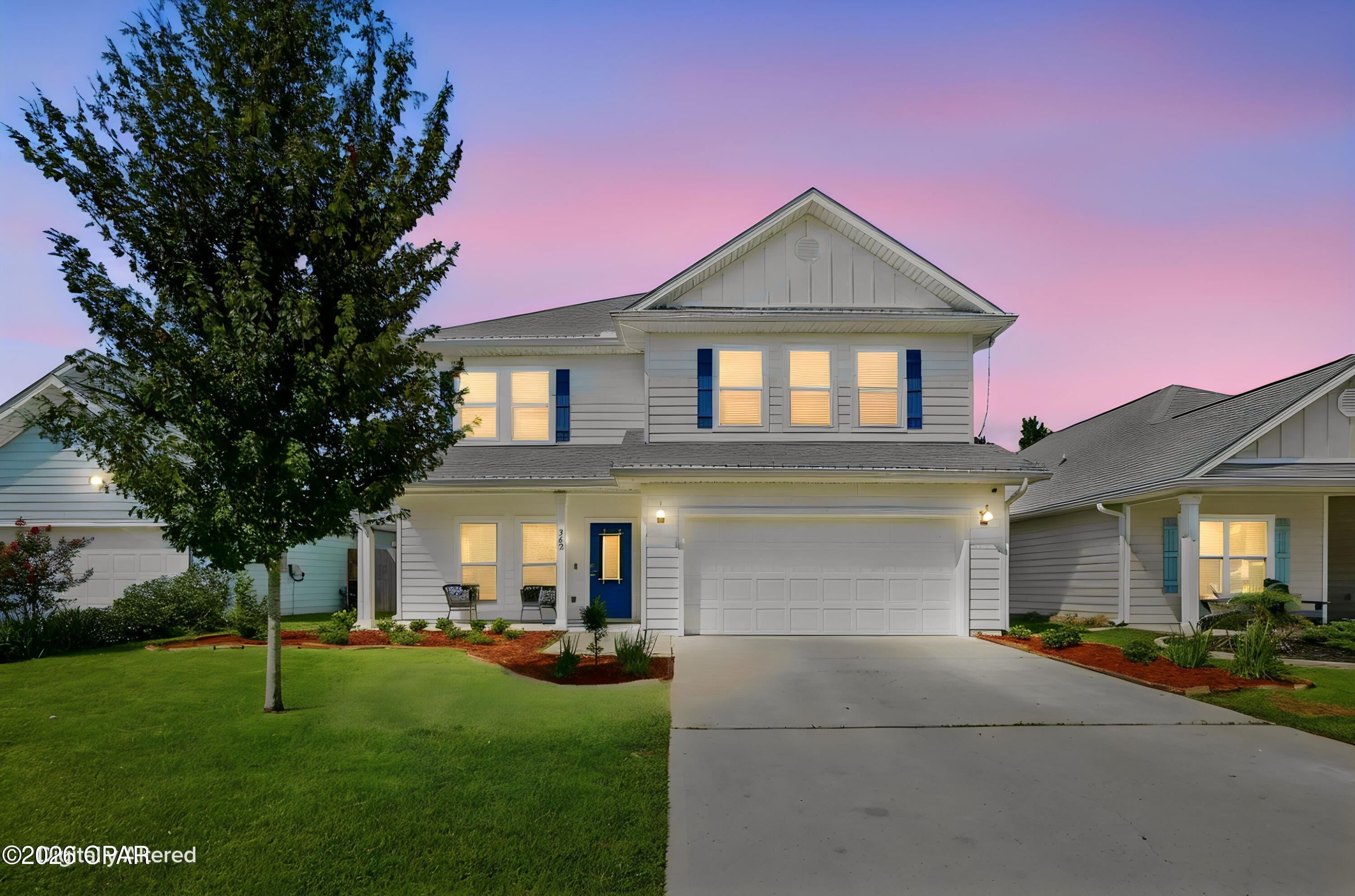 Located in the great coastal community of Emerald Cove Villas, this 4 bedroom 3 1/2 bath, 2 car garage home  with over 2800 Sq. Ft. built in 2021 features  many upgrades from shiplap in living area and other rooms, kitchen backsplash, marble top vanity in guest bath, shell stone floors in front and back porches, no carpet in first level, custom primary bedroom closet,  screened porch, stylish light fixtures to a premium lot backing into natural conservation land providing a serene and peaceful atmosphere.  House is on one of the largest lots in the community.  The primary bedroom is located in the first level for privacy and the primary bathroom has many custom features.  In the second level, you will find a huge bonus/living space, 3 bedrooms and two full baths.  Two of the bedrooms open into a jack and jill bathroom.  The laundry room is also located in the second floor.  The irrigation system covers both front and back yards. The home is wired with a  Smart Home package, keyless entry, an Echo Dot Device and QOLSYS IQ touch panel. The Emerald Cove community hosts sidewalks, streetlights, a dog park and is approved for short term rentals. HOA fees are one of the lowest in the area.  Located a few minutes from the Navy Base, parks, shopping and restaurants.  A few minutes from the Hathaway bridge makes this property very accessible to Panama City.  With an acceptable offer, Seller will paint the whole interior with choice of one color.  Don't miss your opportunity to see this home with lots of upgrades, plenty of room for entertaining and family time.