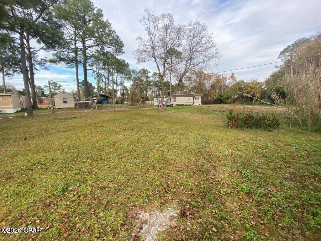 This investment collection is part of 3 lots that can be purchased individually or all together. This one is Parcel ID's 27779-015-000. The mobile home is presently occupied. The property is zoned R-2(BC) which permits two townhomes to be built or a duplex. Buyer can purchase one property or all three at one time. Each property has it's own septic and sewer is available nearby. A power pole is also on each property. 

The drain field for the septic tanks is on this property. 

The white mobile home and the storage unit on 2412 Dorothy A&B does not convey. 

Possible financing available with a builder to build your investment/income property.