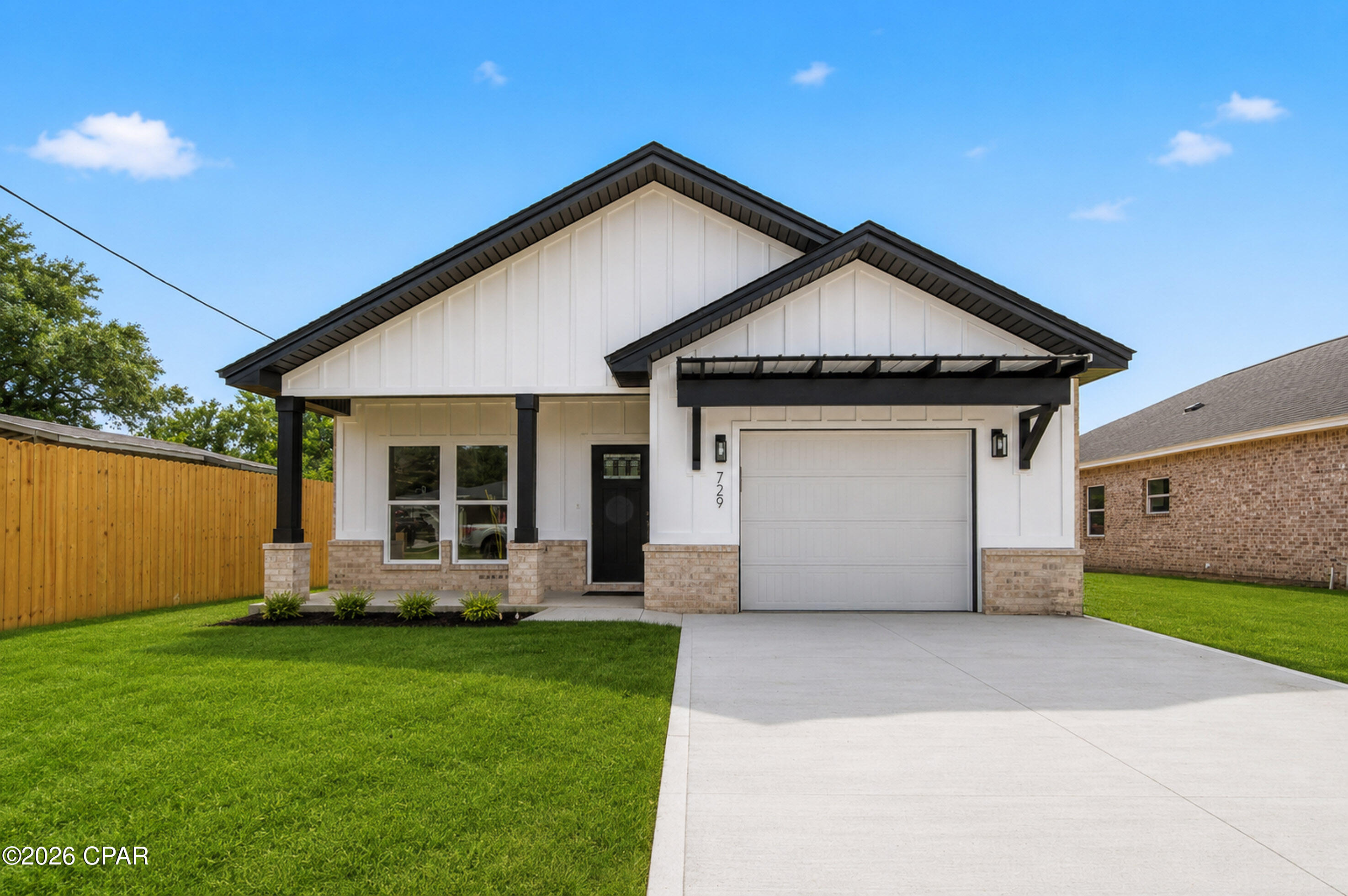 Thoughtfully designed and crafted by a local builder known for quality construction and attention to detail, this exceptional home offers the perfect blend of style, comfort, and modern convenience. The attractive brick exterior provides low-maintenance living and timeless curb appeal, while the covered front porch features stained tongue-&-groove ceilings. Inside, the spacious living area showcases a soaring cathedral ceiling and stunning tongue-&-groove accent wall, creating a warm and inviting atmosphere. 9' ceilings throughout the remainder of the home enhance the open feel. The kitchen is loaded with premium features, including soft-close cabinetry, decorative glass upper cabinets extending to the ceiling, quartz countertops, tile backsplash, a large island, upgraded appliances, deep sink with push-button disposal, and stylish black fixtures and hardware. A spacious walk-in pantry provides excellent storage. Additional highlights include a mudroom with built-in storage, epoxy-coated garage floor, and smart garage door opener. The primary suite features a stained tongue-&-groove tray ceiling, oversized walk-in closet, dual quartz-topped vanities, additional storage cabinetry, and a tiled walk-in shower. Enjoy outdoor living on the covered back porch overlooking the landscaped yard with irrigation system and 8' privacy fence. Conveniently located near Tyndall Air Force Base, Naval Support Activity Panama City, Coast Guard facilities, Panama City Beach, and Mexico Beach.