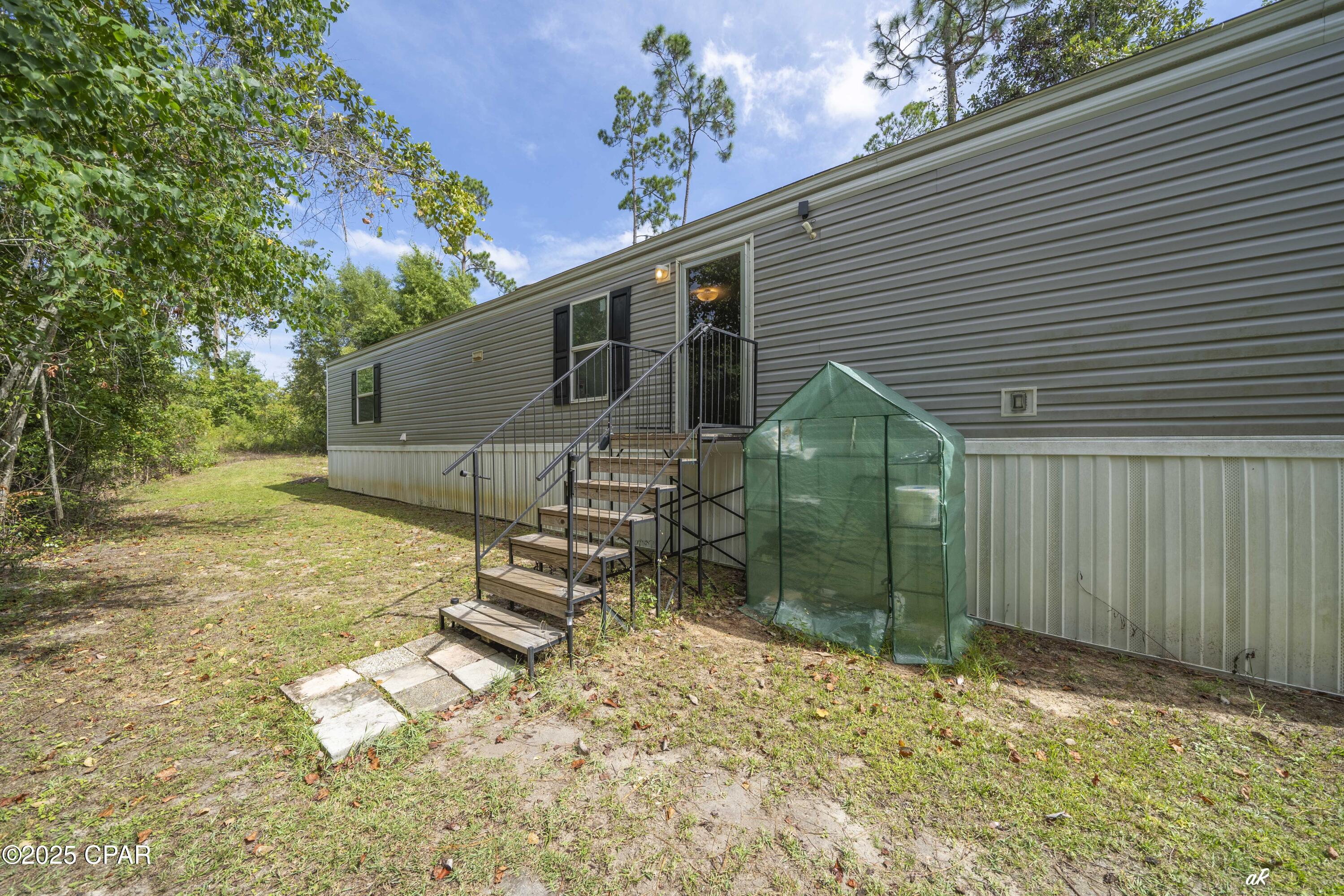 Welcome to this beautifully maintained, modern 2-bedroom, 2-bath single wide mobile home built in 2022 is perfectly situated at in the serene area of Fountain, FL. Positioned just 30 minutes north of Panama City, its convenient location also offers a quiet, country secluded feel while being easily accessible to all the area has to offer. 

Step inside to discover a clean and open floor plan featuring spacious living areas, a well-appointed kitchen with ample cabinet space, storage and sleek finishes throughout. The split floorpan offers sizable bedrooms with generous closet space and privacy, complemented by two full bathrooms designed for convenience and comfort.

Enjoy the peaceful surroundings and the ease of maintenance that comes with a newer home. Whether you're a first-time buyer, downsizing, or looking for a cozy getaway, this property offers the perfect blend of comfort, functionality, and modern living.

Don't miss your chance to own this move-in ready gem in a tranquil location—schedule your showing today!

-Located in flood zone A but have Elevation Certificate on file. 
-Boundary Survey on file.

*Please note, the drop in gate off of the back porch does not convey in the sale.

**Buyer to verify all measurements and information, if important.