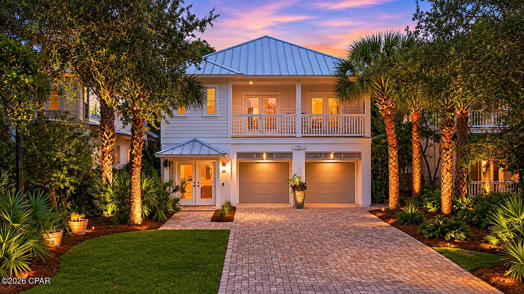 3BR/2.5BA home in Martinique in Panama City Beach. Extensive upgrades, metal roof 2025, pond views, screened outdoor kitchen.  Located in the gated Martinique community on the east end of Panama City Beach, this 3-bedroom, 2.5-bath home offers 2,080 square feet on a 0.11-acre lot with a layout designed for both full-time living and coastal second-home use.  Martinique is known for its Old Florida-style architecture, mature landscaping, ponds, walking trails, community pool, playground, basketball court, and limited inventory of available homes. The neighborhood is positioned near Grand Lagoon, Capt. Anderson's Marina, St. Andrews State Park, public beach accesses, restaurants, and shopping. Inside, all bedrooms are located upstairs, including the primary suite with walk-in closets. The secondary bedrooms have access to the upstairs balcony with new Trex decking that measures approximately 6'1'' by 21'4''. The main living area features ambient lighting, a gas fireplace, and new French doors and windows that bring additional natural light into the home. The kitchen was remodeled with quartz countertops, backsplash upgrades, Frigidaire Gallery appliances, updated sink and faucet, and a convection/air fryer oven. Washer, dryer, and refrigerator convey with the property, and the laundry room includes a second-floor laundry chute.  Recent improvements provide long-term value and peace of mind, including a snap lock standing seam galvalume metal roof installed in 2025, impact-rated windows and doors on portions of the home, updated exterior and interior paint, Honeywell smart thermostats, epoxy garage flooring, and driveway pavers installed in 2025. Additional updates include a remodeled downstairs half bath, three new American Standard Comfort toilets, upgraded electrical, backflow prevention replacement, new fencing, expanded patio space with pavers, exterior lighting improvements, and a termite bond.  Outdoor living is a major feature of the property with a screened porch outdoor kitchen, cooktop, wood-burning outdoor fireplace, hot tub (that also stays with the house), fenced backyard, outdoor shower, and pond views. The oversized garage includes hanging storage systems and keypad access. The home also includes irrigation with two water lines and sprinkler systems already in place.  Martinique is one of the more established gated neighborhoods in Panama City Beach and is valued for its custom homes, walkability, and proximity to boating, beaches, and dining without the density of larger resort communities. Owners can walk to nearby restaurants, bike to St. Andrews State Park, and reach Grand Lagoon marinas within minutes. Short-term rentals are not allowed in Martinique, helping preserve the residential atmosphere many buyers seek on the east end of PCB.