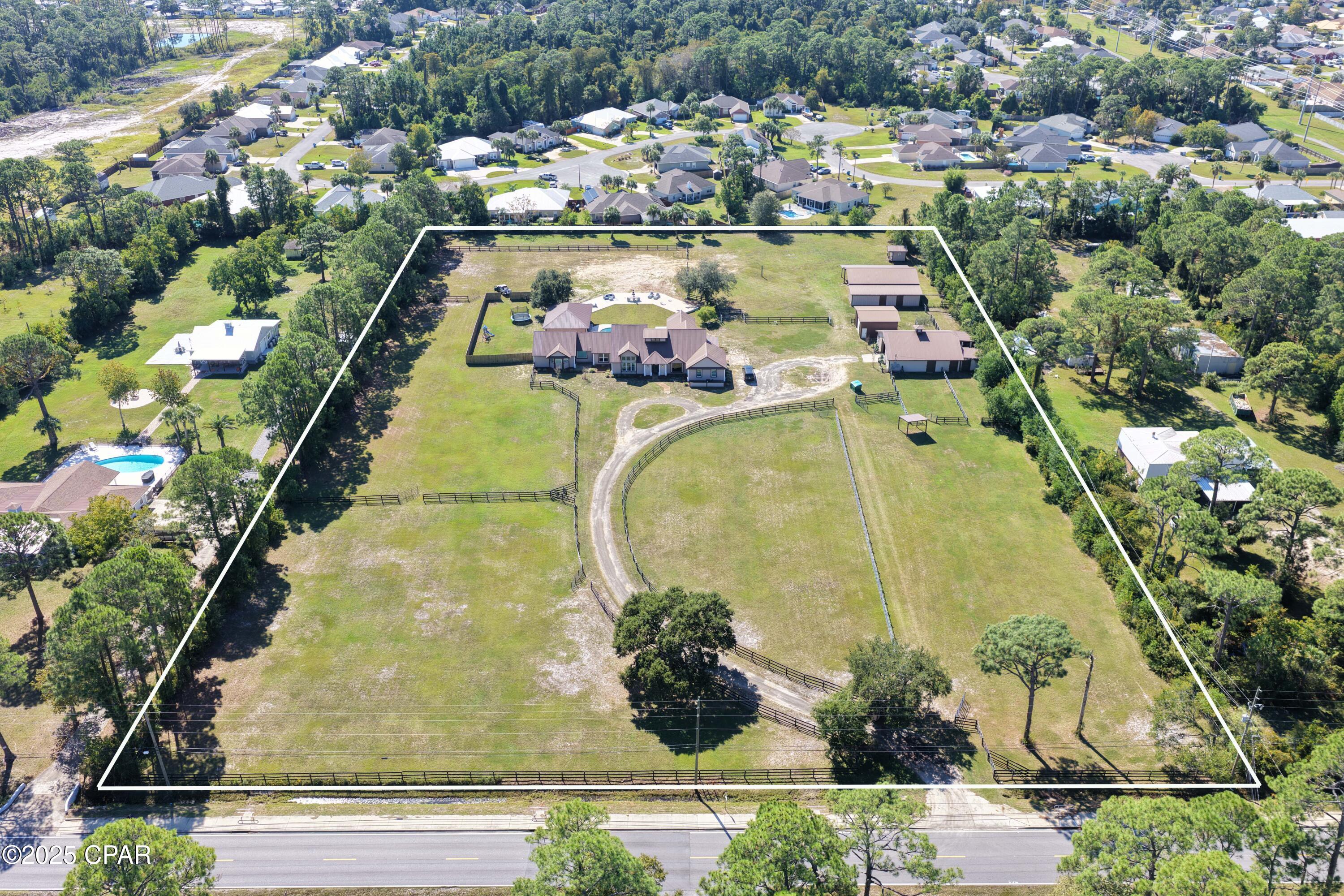 CURRENTLY UNDER CONTRACT, SELLER WILL CONSIDER BACKUP OFFERS' RARE OPPORTUNITY for 6 acres and a horse ranch at the beach!  Only one of its kind!  Discover the perfect blend of a nearly 6-acre private equestrian estate and the beach life in the heart of Panama City Beach.  Enter this property through your remote-control gates and take the winding driveway toward your main home with pool, your 3 barns with 8 stalls and fenced turn outs, and expansive acreage beyond.  The main home was recently remodeled in comfortable luxury and features 4 bedrooms, 4.5 baths, an office/library and bonus room.  No expense was spared in your top-of-the-line kitchen, a chef's dream featuring commercial Subzero and Wolf appliances, including 2 Sub Zero Refrigerators, 2 Cove Dishwashers, Sub Zero Commercial Wine Refrigerator, Wolf Double Gas Range w/ hibachi, pull out beverage drawers, 2 farm sinks, coffee bar (with sink), 2 large islands with copper sinks, warming drawer, Café French baking oven, custom cabinets, commercial ice maker, wine closet and walk in pantry.  Enjoy a spacious family room with vaulted ceiling, hardwood floors, ship lap details, gas fireplace and custom wet bar. This home is perfect for entertaining!  Retreat to your gorgeous primary suite complete with sitting area, his and her private baths, and custom closets.  Beyond the home, there is an additional building with half bath and 2 large doors that can be completely opened up to the outdoors.  This space would be ideal for a workout room, yoga studio, homeschooling, playroom, bonus space or whatever suits your needs and desires.  This dwelling is separate from the main home but can easily be connected if desired.  Step outside the residence to your backyard oasis with large covered back porch, glistening pool, and endless potential for outdoor entertaining and activities.  Come experience life at 7609 Laird Street, take advantage of this sweeping 6-acre property; and bring your horses and animals too!  3 barns, a fenced in area for dogs, and lots of land!
Barn #1
6 Stalls, tack room, horse washing station and hay loft.
Barn #2
Enclosed and dry! Perfect for storage!
Barn #3
Pole Barn with two birthing stalls.
This is a true lifestyle property, perfect for entertaining, or secluded ranch life, and only 5 minutes to the Gulf of Mexico!  Call today!