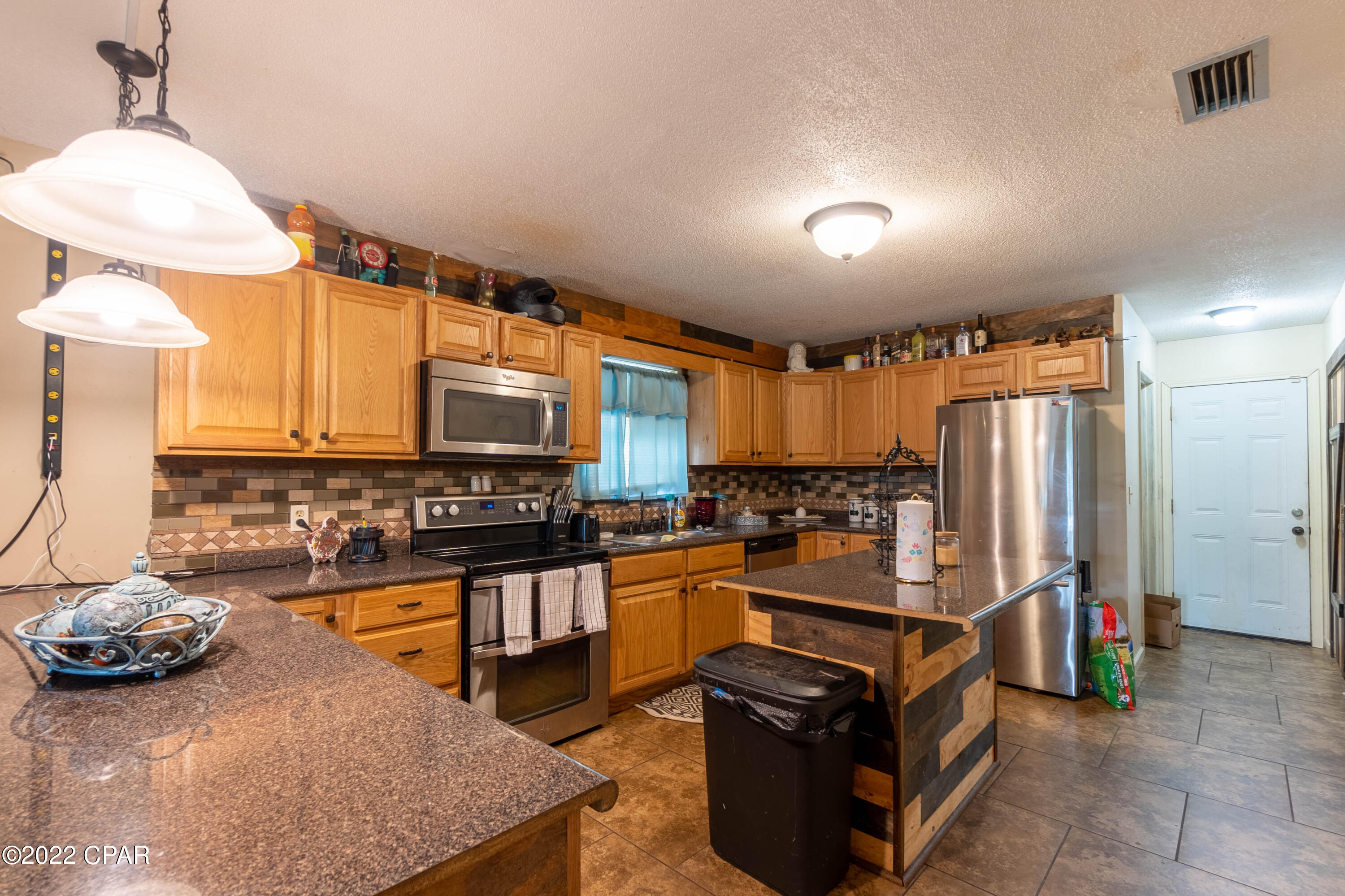 4-bedroom brick home centrally located &  minutes to Tyndall Air Force Base.  No HOA / No Flood Insurance required, located on nearly ½ acre with room for a Pool, Family, Friends, and Pets.   Beach is an equally short distance (East) to Mexico Beach or West to Panama City Beach.  As you enter the home, to the right is the kitchen, garage access and breakfast nook with French Doors leading out to the Partially Screened Covered Patio and on the left the bedrooms/Baths. All electric, Public water, and money saving septic. All info approx., buyer to verify all deemed important.  Callaway is growing with access to popular new restaurants, local businesses, gyms, and shopping. Call today to set up a private showing. 628 Colonial Dr features a partially fenced back yard, Flagpole, Irrigation well, Public Water, Private septic.  This home irrigation well pump currently not working without plans for repair.  This home is located in an eligible area for Zero down payment Loans with Local Lenders.  Put this home on your list first to see!