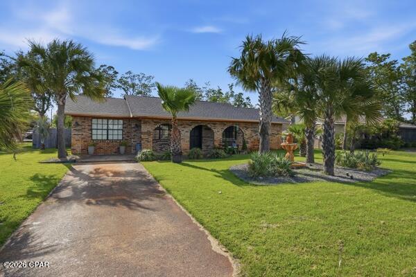 Welcome home to this charming all-brick beauty in the highly desirable Lynn Haven area! Perfectly situated on a large corner lot, this spacious 3-bedroom, 2-bath home offers room for everyone with multiple living areas and endless flexibility.

From the moment you walk in, you'll love the warm and inviting feel, featuring a formal living room, comfortable family room, and a large bonus room that could easily be used as a 4th bedroom, home office, playroom, or guest space. Whether you need room to grow, work from home, or entertain, this home offers options to fit your lifestyle.

The open kitchen is ideal for gathering, complete with a cozy eat-in breakfast area plus a separate formal dining space for family dinners and holiday entertaining. Stylish shiplap accent walls add charm and character, while the beautifully landscaped yard creates fantastic curb appeal.

Major updates have already been taken care of, including updated electrical, a newer roof (2022), A/C system (2021), and tankless gas water heater (2021), giving buyers added confidence and peace of mind.

Step outside to enjoy the fully fenced backyard featuring an above-ground pool, perfect for cooling off on warm Florida days, entertaining family and friends, or simply relaxing at home. The beautifully maintained yard is enhanced by a sprinkler system with its own well pump, helping keep the landscaping lush and green year-round. The property also offers side gates for boat, trailer, or oversized vehicle parking, adding both convenience and versatility.

Located close to shopping, schools, dining, and major roadways, this home combines space, comfort, and convenience in one fantastic package.