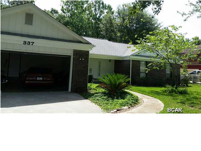 Spacious open floor plan - 18x19 great room with cathedral ceiling and wood burning place. Large kitchen with wood  cabinets, breakfast nook, plus a formal dining room. Master bedroom is 13 x 14.3 with master bath double vanity (one in dressing area) and a fiberglass shower. Large half acre lot with nice thick carpet of centipede grass. The backyard is chain link fenced with a double gate entry for boat or RV. The well built workshop 18x24 has a single garage door. Extra attic insulation, plus extra in the wall between great room and master bedroom for quietness. Dbl oversize garage with storage above. 14 SEER HVAC, electric water heater w/ timer, wood deck recently washed and painted. Roof replaced in 2007. County taxes only, no treated water as well and septic. No association dues!! is a great home located near Lynn Haven! County location so pay no city taxes and no water bills! Shallow well for the sprinkler system with a new 7 zone automatic timer. Lots of closets!