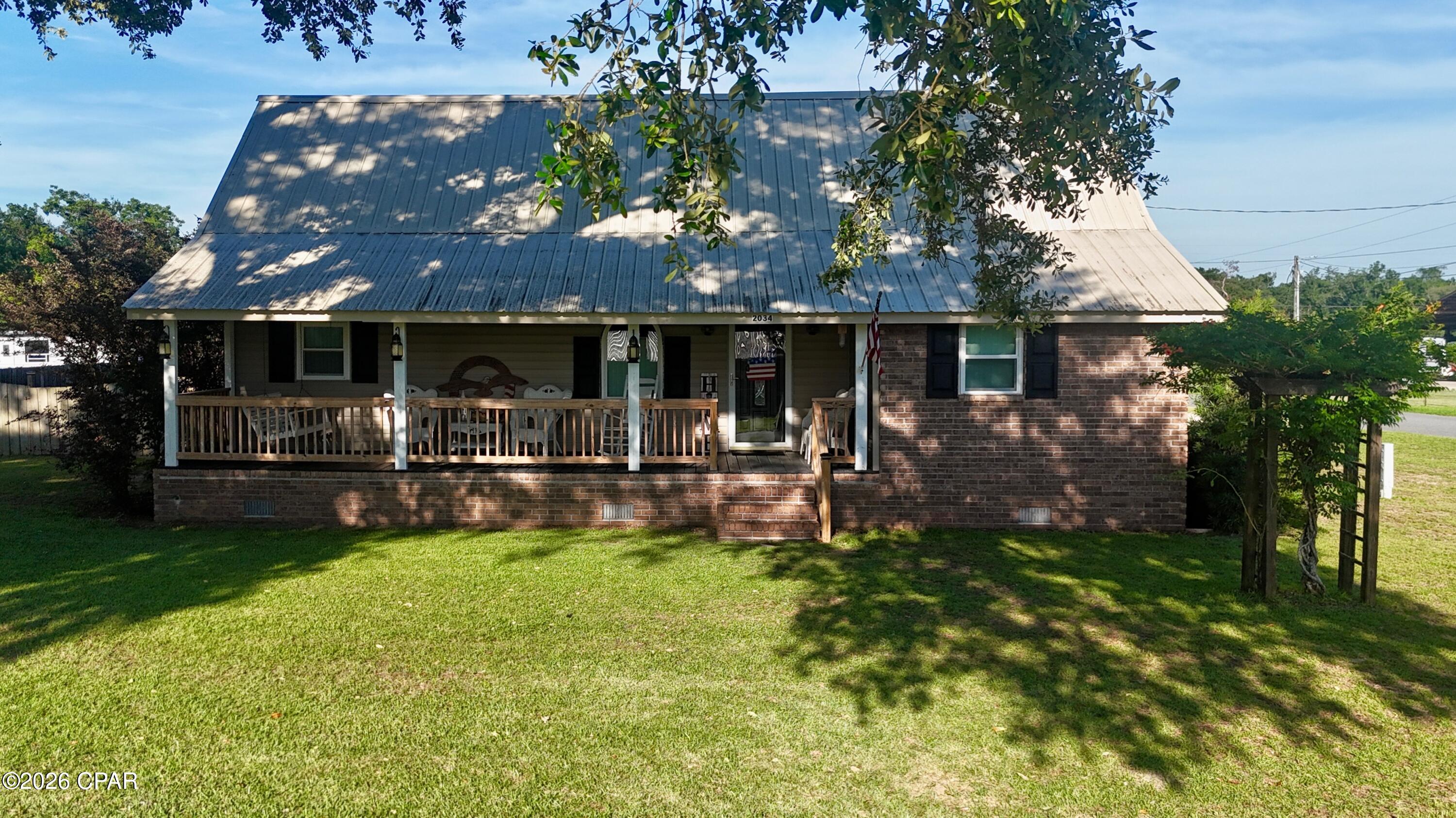 Welcome home to this well-maintained 3-bedroom, 2-bath brick home offering just under 1,700 heated and cooled square feet in the peaceful Cypress/Grand Ridge area. From the moment you arrive, you'll appreciate the beautiful, shaded yard featuring mature oak trees, along with producing plum and fig trees that add character and charm to the property.



Enjoy your morning coffee on the inviting front porch or unwind in the evenings on the spacious back porch overlooking the picturesque yard. The property also features a pole barn-style carport with a concrete floor, providing excellent covered parking and storage space.



Inside, the home has been exceptionally cared for and offers a warm, welcoming feel throughout. The interior is beautifully maintained, tastefully decorated, and move-in ready. Whether you're looking for a primary residence or a peaceful country retreat, this property offers comfort, functionality, and timeless appeal in a desirable North Florida setting.