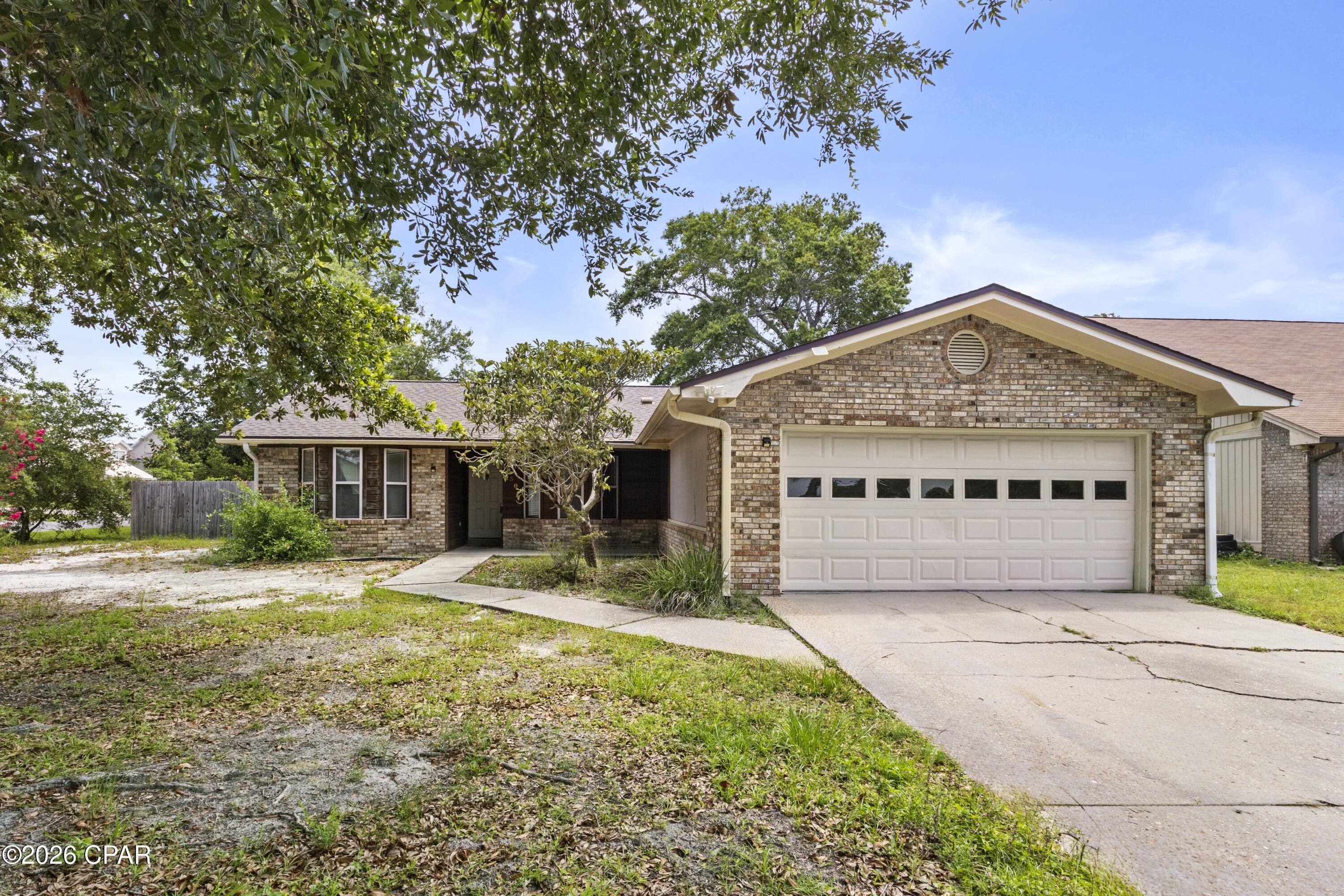 Affordable brick home near Tyndall AFB offering 3 bedrooms, 2 bathrooms, and a versatile floor plan designed for comfortable living. The open layout features split bedrooms for added privacy and two living areas, giving you the flexibility to create a home office, playroom, or potential additional bedroom. New carpet and fresh interior paint provide a clean, move-in ready feel, while neutral finishes complement a variety of decorating styles. Situated on a corner lot, the home also includes a 2-car garage, a privacy fenced backyard, an open patio for outdoor entertaining, and a welcoming covered front porch. Enjoy being just around the corner from a scenic walking path around a pond and conveniently located near public parks, a public boat ramp, and Tyndall AFB. This home offers comfort, convenience, and value all in one package.  Call today for a private preview.