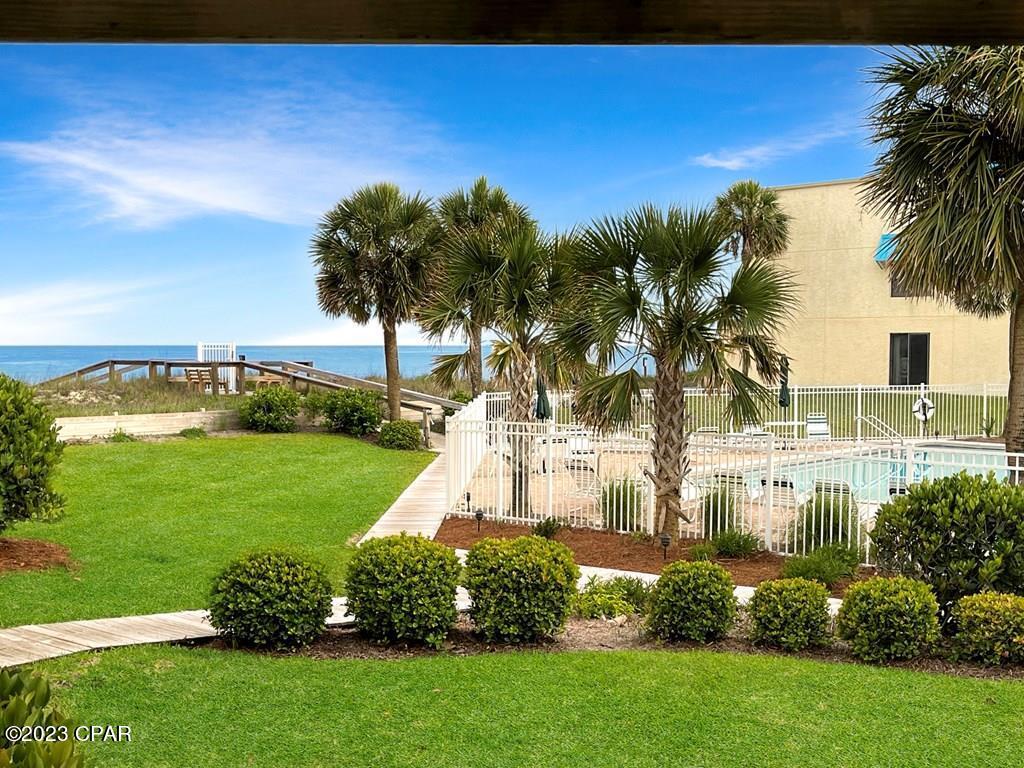 INVITING 2BR/2BA BEACHSIDE VILLA WITH GULF VIEWS AND COMMUNITY POOL ON BEAUTIFUL ST GEORGE ISLAND! Live the beach life in a recently upgraded ground floor unit complete with an open floor plan, wood grain tile flooring and relaxing patio space. Cozy and bright, the living area flows seamlessly into the kitchen featuring breakfast bar seating, fresh white cabinetry and stainless steel appliances. All on one level is a welcoming primary suite with private patio, stand alone tiled shower and dressing vanity. Down the hallway is a second guest bedroom retreat matched with a well appointed hall bath and laundry. Reasonable HOA dues cover Flood Insurance, water and cable. This income producing property is rental ready and well maintained with a newly installed HVAC system. Near restaurants, shopping and only steps to miles of white sand and uncrowded beaches. Make this your next vacation destination or investment. Don't delay! Call for a showing & present your offer on this property today!