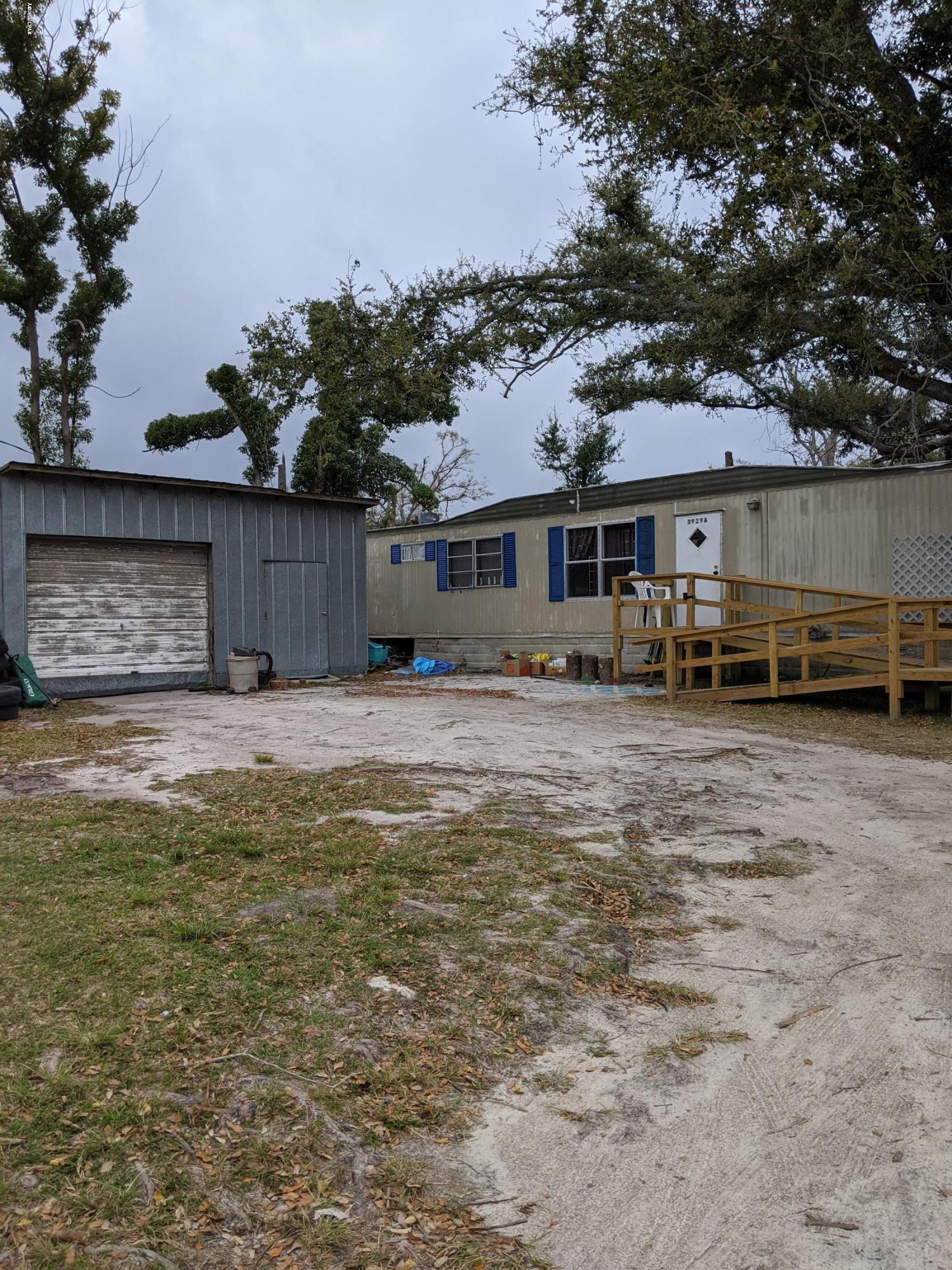 Clean 2 bedroom mobile home on a large 1.5 acre lot within the city limits. This home is move-in ready and sustained no known damage from hurricane Michael. This home comes complete with access to the pond that is partially on the property, a very large metal shop building and a ramp that makes it accessible by wheel chair. Great investment opportunity or perfect to move right in. The home has been renting for $700/month. All Measurements are approximate verify if important.