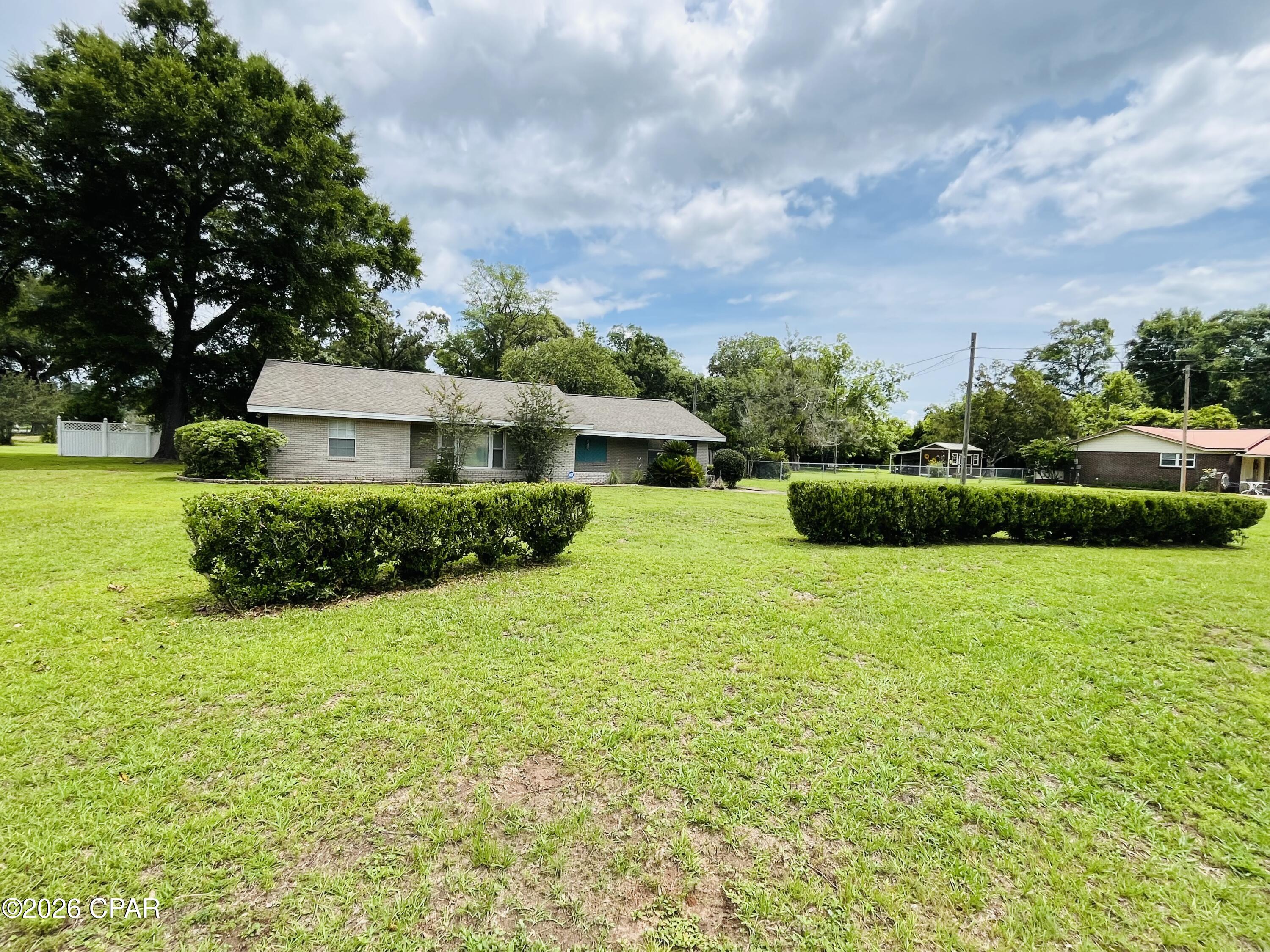 Discover peaceful country living just minutes from the renowned fishing paradise of Lake Seminole. This spacious brick home sits on a beautifully maintained 1.6± acre lot, offering the perfect blend of comfort, privacy, and room to enjoy the outdoors.

The property features multiple exterior structures that provide endless possibilities for hobbyists and outdoor enthusiasts alike. Whether you envision a mechanic's workshop, home gym, entertainment space, or ample dry storage, these versatile buildings offer the flexibility to create the perfect setup for your lifestyle.

A paved driveway leads to a four-bay detached garage with commercial-grade roll-up doors and a restroom, along with a two-car carport that provides abundant covered parking and storage for your vehicles, boat, camper, ATVs, and other recreational gear--ideal for anyone who enjoys life on the water or exploring the great outdoors. The carport also includes an attached mother-in-law suite, perfect for guests or extended family.

Conveniently located, this property offers the tranquility of rural living while remaining within approximately one hour of Tallahassee, Dothan, and Panama City, making it an excellent option for commuters, weekend getaways, or a full-time residence near the lake.