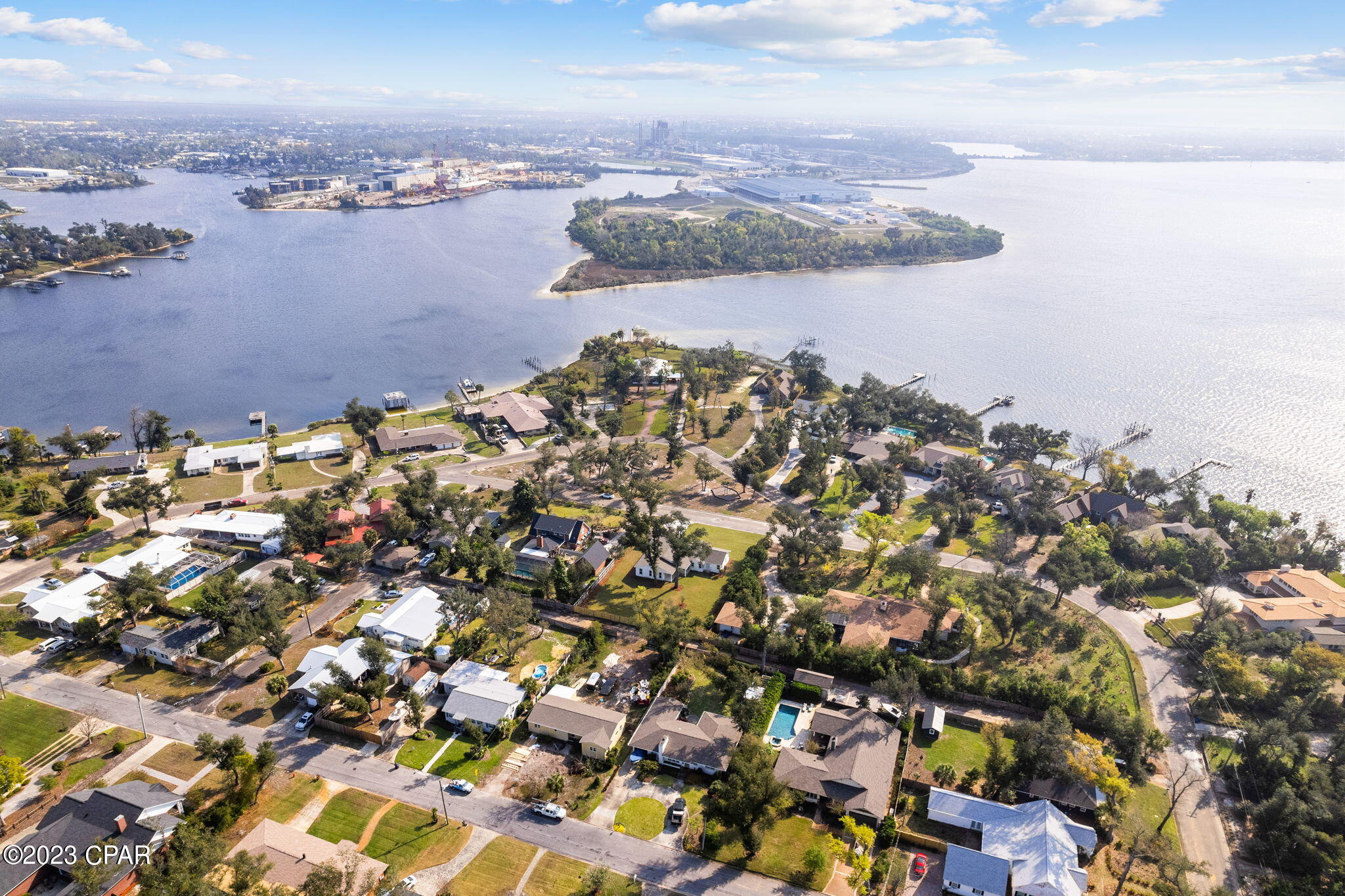 An incredible opportunity own a home with water views of the Bay on nearly a half acre in the Cove. This homesite sits across from a neighborhood park and has been completed renovated down to the studs and had almost 1,000 SF added to the home. This home was designed for a true split floor plan to include a 500 SF master suite with vaulted ceilings, private covered patio, marble tile floors and shower in the en suite as well as an oversized walk-in closet. The vaulted living room features a shiplap fireplace and double French doors leading to the covered patio and incredible back yard with hundred year oak trees. The kitchen was expanded and offers custom griege cabinetry, GE Cafe appliances, natural gas 5 burner range and an unbelievable amount of pantry space. The new 6" oak hardwood floors flow throughout the house including the added powder room off the living area. A family room was created off the kitchen for multi-use options for growing families. The three guest bedrooms, one including an en suite, are all located on the left end of the home. Recessed lighting was added throughout the home, two new HVAC units, new plumbing to the street, new tankless gas water heater, new electrical, triple insulation, new roof, new interior and exterior doors, new windows, new garage door and driveway. The exterior has been remastered with new board and batten and fits perfectly under the canopy of hundred year oaks. Sod and irrigation was installed in the front and back yard of the home. Underground electrical and new natural gas line was installed for the home and a 200 amp service for recreational vehicles, future pool/spa or shop. This home offers a one car garage and an oversized two car carport for tall vehicles/boats/recreational vehicles. This home is a true masterpiece and was gutted down to the studs and with the new addition, created an almost new construction home. Welcome to the Cove in a truly remarkable, remodeled home!