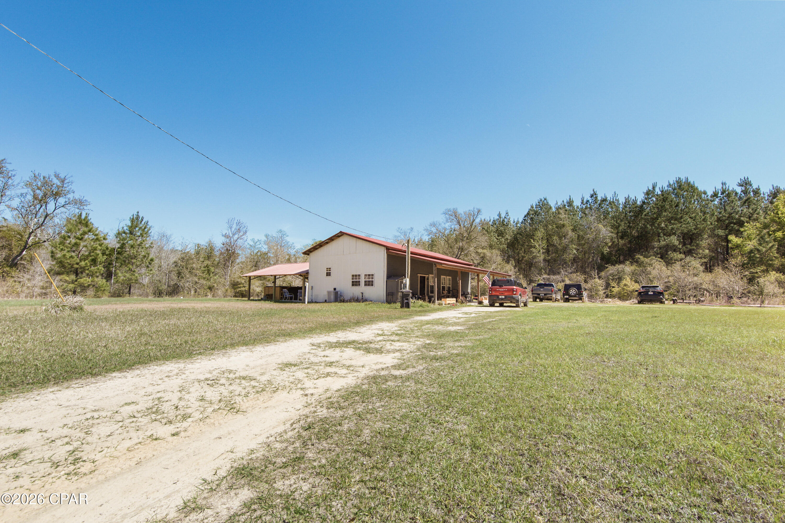 CURRENTLY UNDER CONTRACT, SELLER WILL CONSIDER BACKUP OFFERS
The Modern Homestead: With More Character than a John Wayne Marathon! 
We're burning daylight over here! Tucked away just outside of Bonifay, this 21.51-acre estate is the ultimate ''getaway'' that you never have to leave.  If you've been looking for the ultimate escape where modern integrity meets old-world soul, this is your destination. 
The Barndominium: Where Grit Meets Glamour.
Forget what you know about ''rustic.'' Built in 2022, this custom barndominium blends the structural integrity of a modern build with the soul of a vintage farmhouse.
Adorned with a vintage, artisan interiors -  Stepping inside is like walking into a magazine. Adorable, warm, and rich with reclaimed materials that tell a story.
A massive, open-concept living space welcomes you home - designed for entertaining or unwinding after a day in the woods.  The master suite features a walk-in closet so large it's practically its own zip code. (This space could be a ''blank canvas'' and easily converted into a bunk room or home office).
Both the kitchen and bath are perfectly appointed with ''rustic-chic'' finishes that prove you don't have to sacrifice style for the country life.
21 Acres of Opportunity! 
Comes with it's own privacy screen! The front of the over 21 acres features a lush, natural wetland buffer providing an organic area that shields the homestead from the road. Once you pass through, you enter a high and dry paradise shaded by massive, mature trees. It's quiet, it's secluded, and it's yours.
Relax on more than one level! Unwind in your private swim spa--the perfect way to cool off after a morning of land management or hunting. The ultimate year-round luxury for fitness and relaxation.  Worth mentioning - Includes a pole barn and multiple sheds. Whether you have tractors, ATVs, or a woodshop hobby, there's a place for it.
This is the ultimate ''set-and-forget'' property. Use it as your primary residence and breathe the fresh air or keep it as the world's most sophisticated hunting lodge. With 21+ acres, there is limitless room to expand.
The sellers are ready to pass the torch! Properties with this much acreage and a 2022 build do not last in this price bracket. 
''I'm looking for a place where a man can breathe'' John Wayne. Giddy up, John. This is that.
