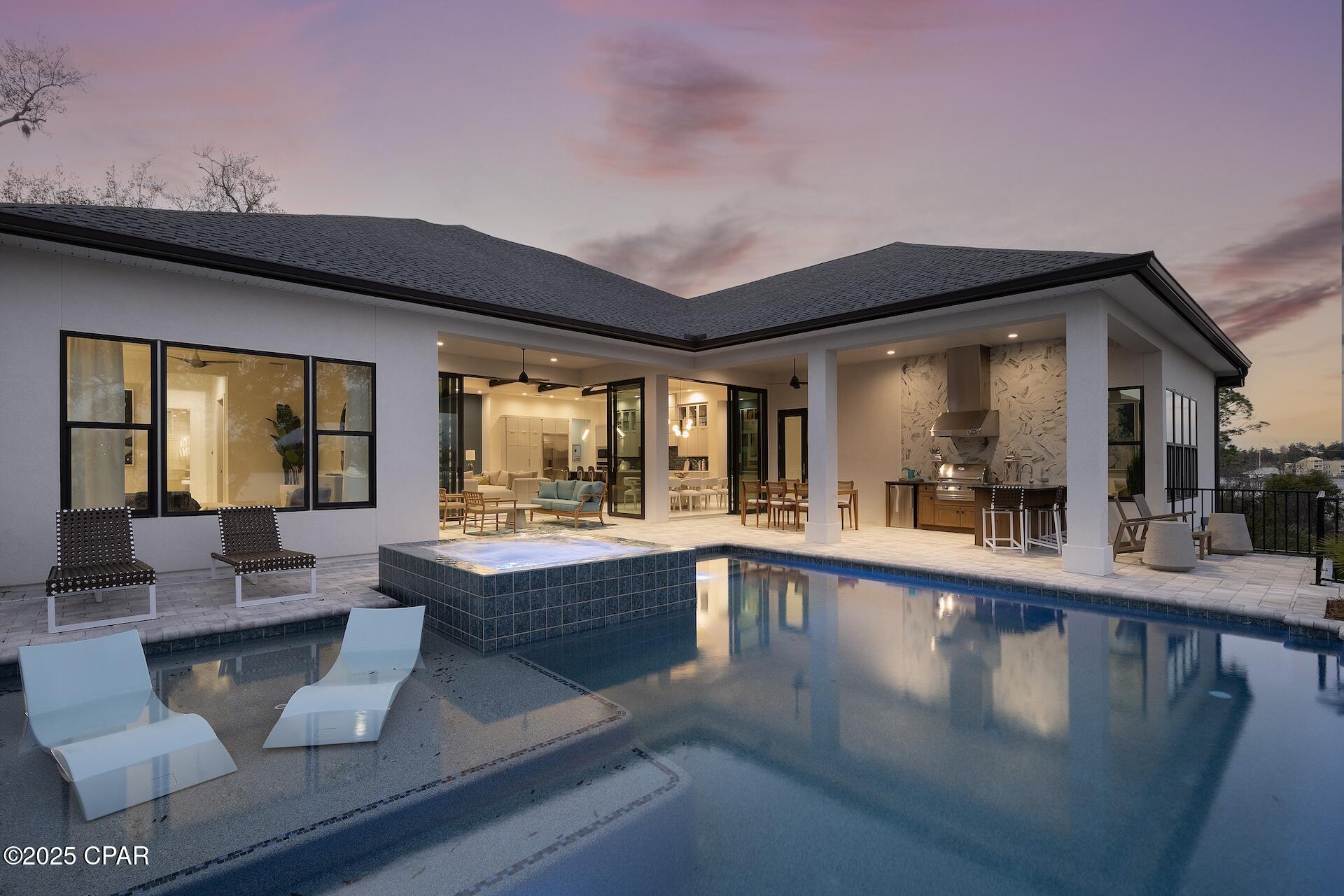 Waterfront Luxury - Fully Furnished Arthur Rutenberg Home - where elegance meets effortless living. This fully furnished, professionally decorated AR Homes by Arthur Rutenberg Home offers over 5,000 total square feet under roof and is ready for immediate move-in. Situated on 154 feet of deep-water bayou frontage, this 4-bedroom plus den residence showcases soaring vaulted ceilings, exposed beams, and designer finishes throughout. The home includes a Home Delivery Center for secure, contact-free package drop-off, and features expansive disappearing glass walls that open to a resort-style outdoor living area with a vanishing-edge pool, outdoor kitchen, lanai, and cabana. Located in the upscale community of Cove Pointe, with low HOA dues, this exceptional property offers direct access to Shell Island and the Gulf of America. Offered fully furnished, this is a rare opportunity to own a turnkey luxury waterfront home designed for both everyday comfort and high-end entertaining.