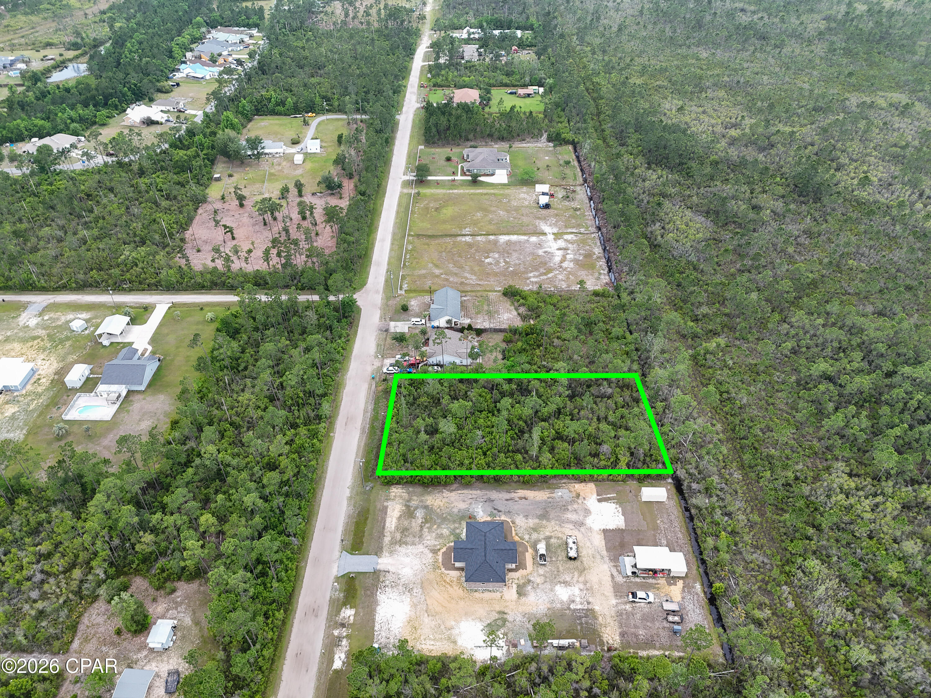 Looking for land but overwhelmed by permits, wetlands, and all the ''extra stuff'' that usually comes with building? This property already has much of the hard work completed for you.

Welcome to 12109 Caruso Drive in Panama City, Florida -- an approximately 0.97-acre homesite with an approved Environmental Resource Permit already in place for a single-family home, pool, garage, yard, and driveway. 

What does that mean for you?
It means the current owner has already gone through the lengthy and expensive environmental permitting process that many buyers don't realize can take months -- sometimes over a year -- to complete. Surveys, environmental studies, wetland evaluations, engineering plans, and mitigation requirements have already been addressed, potentially saving a future buyer significant time, stress, and thousands of dollars in upfront costs. 

Instead of starting from scratch, you can move forward with a property that already has a development plan approved through the state for a homesite with room for outdoor living and a pool. Public water and sewer are available at the road, along with electric access, making the building process even more convenient.

The property offers a peaceful, natural setting while still being close to shopping, schools, dining, and everything Bay County has to offer. Whether you are planning your forever home, a private getaway, or simply investing in land for the future, this parcel offers flexibility and opportunity.

Even better -- the seller is offering owner financing with only $14,000 down, making it easier to secure land now without traditional bank financing.

Build sooner. Skip months of permitting headaches. Save money on upfront environmental work. And start creating your vision on a property that is already one step ahead.