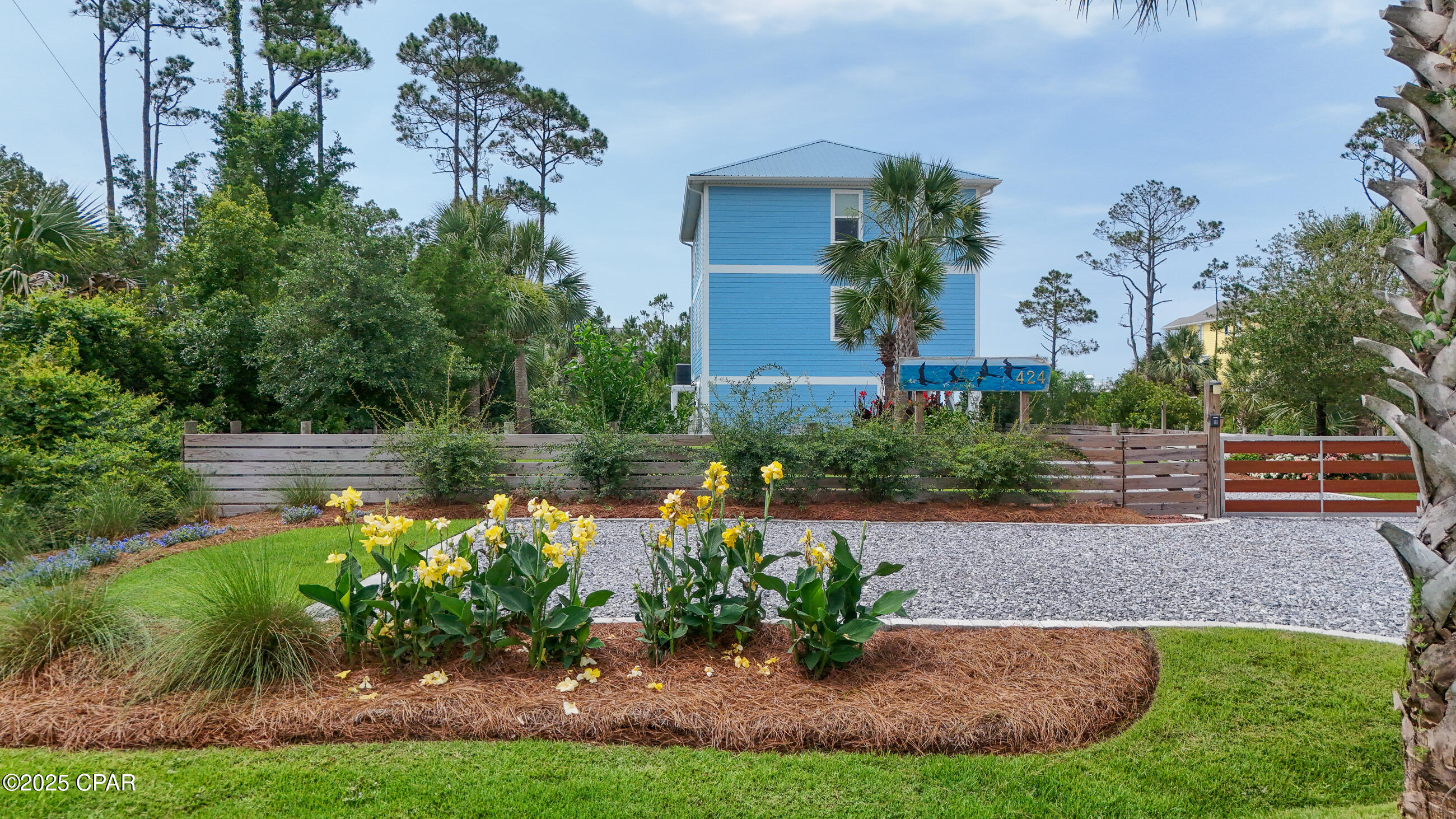 This beautifully updated 4-bedroom, 3-bath coastal retreat offers breathtaking panoramic views of both the Gulf of Mexico and Indian Lagoon—the best of both worlds! Just 120 steps from your private, deeded beach path, you'll find a peaceful beach where you can unwind and watch the sun dip below the horizon. Inside, the home features a light, open floor plan with driftwood-style tile flooring, custom shiplap accents, and a beachy, designer interior complete with custom window and wall treatments. The kitchen is equipped with Samsung stainless steel appliances, Corian countertops, and plenty of space to entertain. With two spacious en-suite primary bedrooms (one on each level), each opening to outdoor sunrooms through French doors, there's room and privacy for everyone. The owner has recently enclosed both decks to create versatile Florida rooms, each with split-unit A/C systems and ceiling fans, ideal for enjoying the views year-round. This home has seen a number of thoughtful upgrades that enhance both its functionality and charm. The exterior features lush, professionally designed landscaping, including fruit trees, fresh sod, and an irrigation system. A fully fenced yard offers privacy and is ideal for pets, while a gated entrance with automatic openers and keypad access, along with a separate walk-through gate, provides both convenience and security. Both upper and lower decks have been enclosed to create bright and breezy Florida rooms, each equipped with split-unit air conditioning systems and ceiling fans, allowing for year-round enjoyment of the surrounding views. Inside, you'll also find new custom blinds throughout, adding a fresh and finished look to every room. Tucked into the natural beauty of Indian Pass, this home offers the serenity of Old Florida charm with the modern comforts you deserve. Don't miss your chance to own this exceptional slice of paradise!