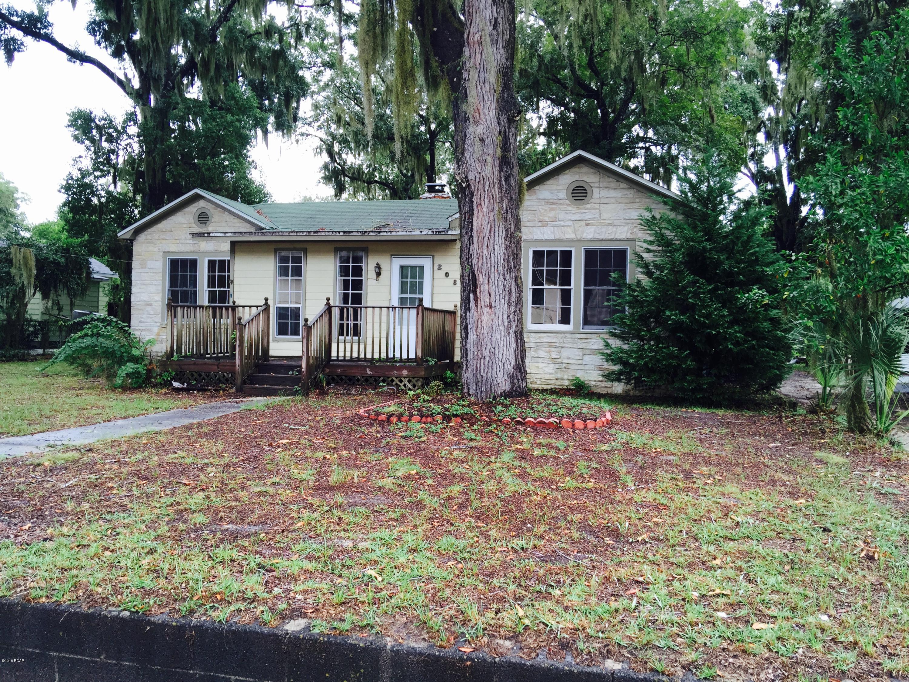 Lovely 3 br/2ba stone and shingle home on a large lot close to the Bay in the beautiful Cove area! One block from the Bay and Beach Drive, this home is close to schools, shopping, entertainment, and the waterfront. The interior has lovely hardwood floors, nice sized master bedroom, is handicap accessible, large back porch, and a storage building in the back yard. One of the bedrooms is equipped with a handicapped bathroom. This very large lot allows for as much expansion as you'd like! Plenty of room for a pool and/or carriage house. Majestic oak trees line this large partially fenced-in yard and this quiet neighborhood has all the privacy and peaceful nature of the Cove.