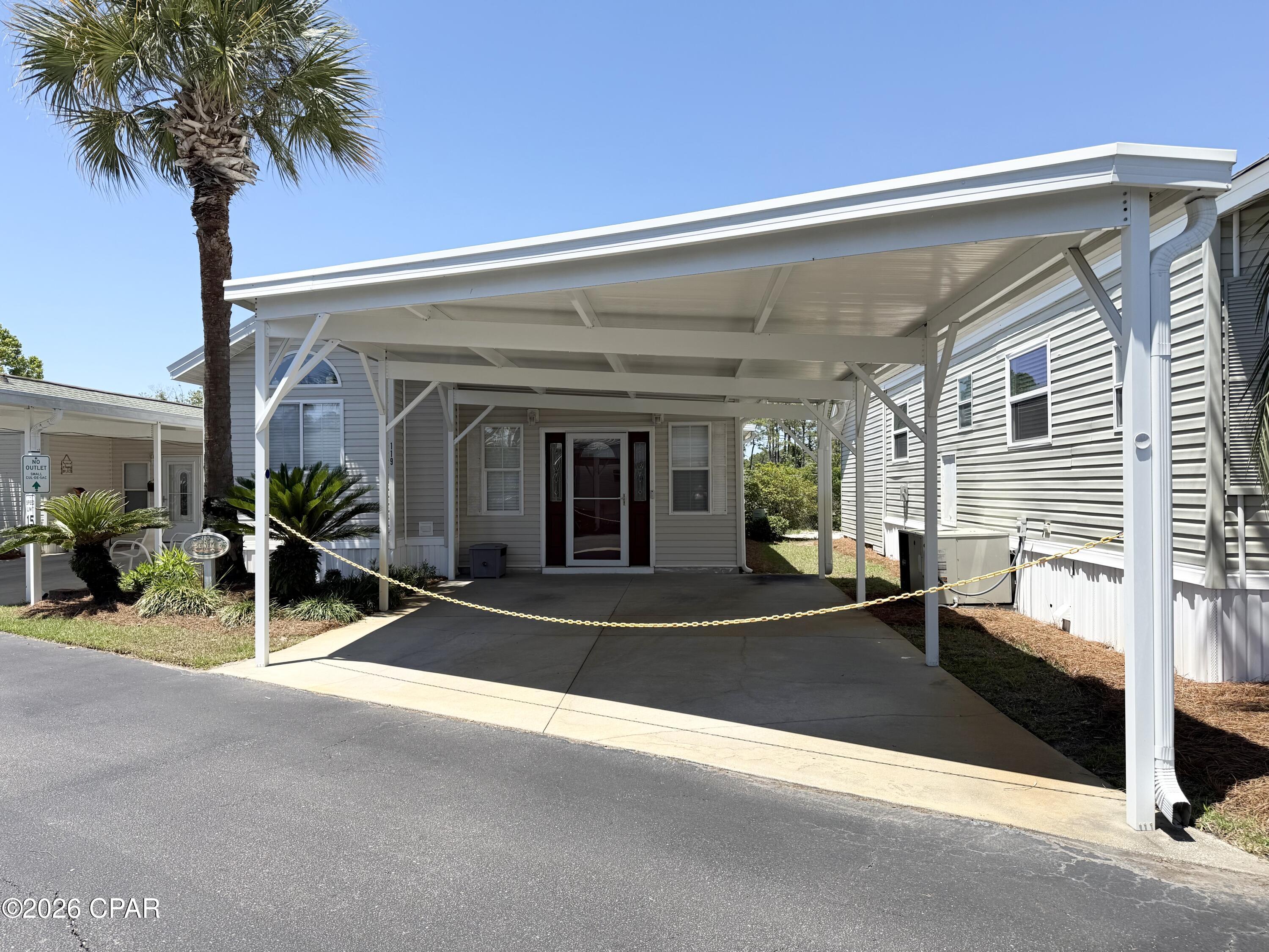 CURRENTLY UNDER CONTRACT, SELLER WILL CONSIDER BACKUP OFFERS - Well-maintained and impeccably cared for, this charming 2-bedroom, 2-bath home is located in the beautifully landscaped, gated community of Emerald Pointe Resort! Conveniently situated off Navy Blvd, this property offers easy access to Naval Support Activity Panama City, area golf courses, marinas, shopping, dining, and the white sandy beaches of Panama City Beach.  Enjoy resort-style living with outstanding community amenities, including a spacious clubhouse with a full kitchen, fitness center, two pools (one heated), hot tub, playground, shuffleboard, horseshoe pits, and a lakeside pavilion overlooking a catch-and-release fishing lake.  This move-in-ready home has seen numerous recent updates, including new engineered flooring, a new HVAC system, new water heater, newer roof, and a newer two-car carport. The enclosed rear sunroom with glass windows and a private door offers flexible bonus space. The utility room includes a washer and dryer along with a large 40-gallon water heater for added convenience.  HOA fees cover water, sewer, lawn care, sprinkler system, cable TV, trash pickup, and full access to the community amenities, making for easy, low-maintenance living. Whether you're looking for a primary residence, vacation getaway, or investment opportunity, this home is a must-see!