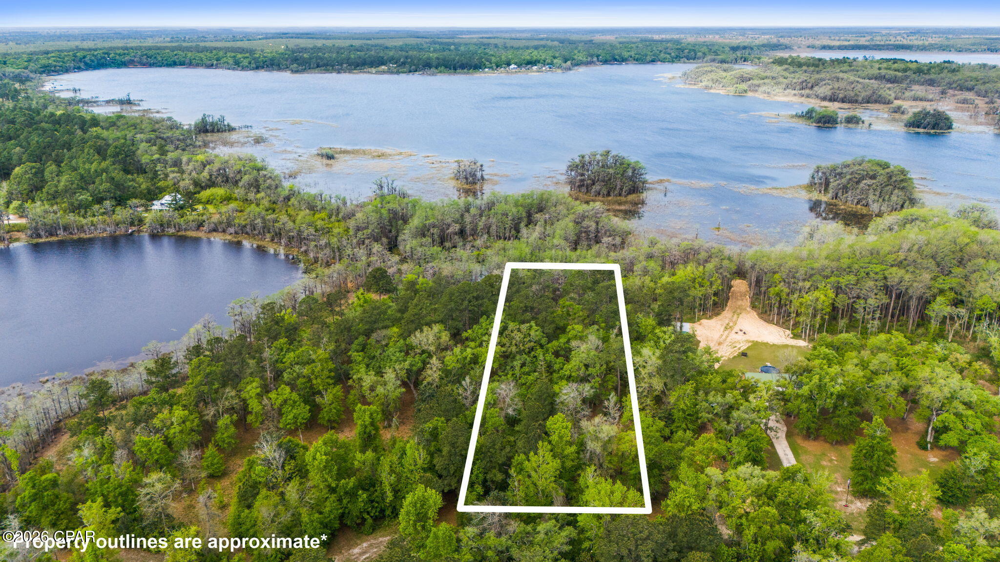 Very peaceful 1.58 acre waterfront property  on Lucas Lake located inside the gated community of Paradise Lakes. If you are looking for a serene, beautiful place to build a home this is it! Single Family or Manufactured Homes are allowed. Underground utilities are in place.  There is also a community boat ramp with access to Dunford Lake. It is restricted to boats of up to 25 HP and a maximum speed of 15 mph. HOA fees are $200 per year.  Don't miss taking a look at this gem of a community. Must have gate code to enter.