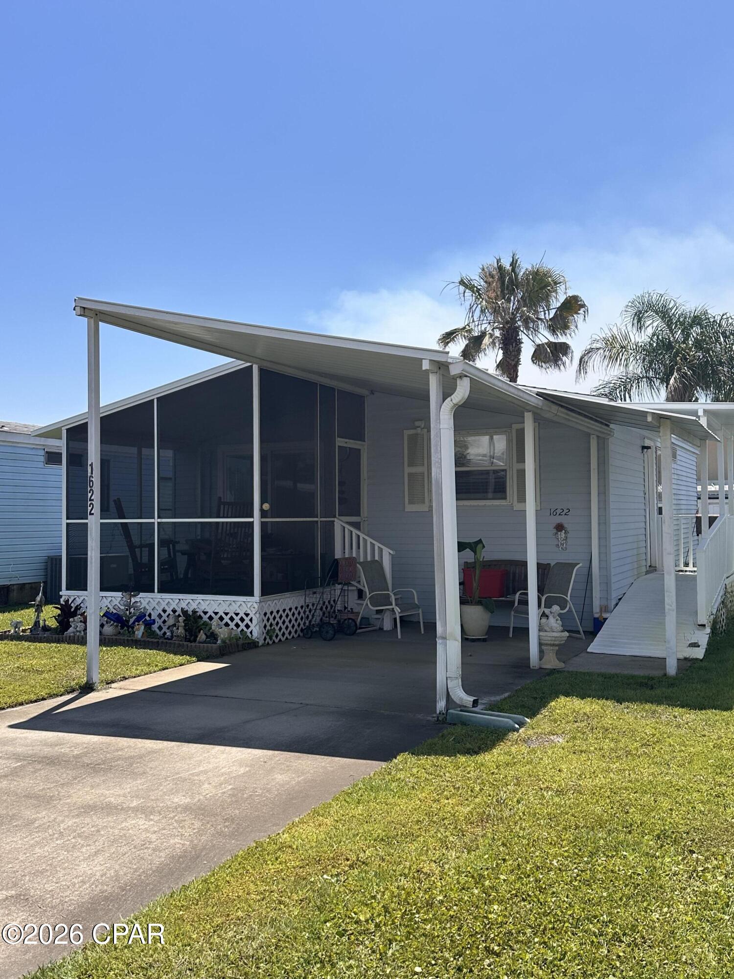 Just minutes to the beach. 55+ community. Monthly HOA payment covers Xfinity Wi-fi and basic cable, water, sewage, garbage, yard maintenance, pool and clubhouse maintenance. There is also a gated RV/Boat storage area. No lot rent since you own the land!  This property offers a convenient location, close proximity to the beach, and a low-maintenance lifestyle. 
Screened in front porch and covered carport. Wheelchair accessible. Located within close proximity of shopping, dinging, and local attractions, making this property an excellent value. Short-term rentals are not allowed. Schedule your showing today.