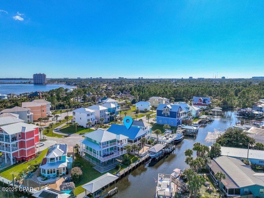 Stunning Waterfront Home with Gulf Access and Deep Water Boating Amenities. Don't miss this incredible opportunity to own a newly renovated waterfront retreat with direct access to the Gulf! Situated in a secluded, gated community, this home is a boater's paradise, complete with a deep-water boat slip and boathouse. Step outside to enjoy Florida's fabulous weather on two oversized, southern-style screened porchesâ€”perfect for entertaining family and friends. Inside, the home features exquisite finishes, including light sand-colored quartz countertops in the kitchen and bathrooms, complemented by immaculate white cabinetry and modern gold hardware for a clean, sophisticated look.
Elegant, opaque white tiled showers and a convenient outdoor shower provide multiple options to refresh after a day at the beach or on the water. Pale wide-plank wood tile flooring runs seamlessly throughout the home, adding warmth against the charming white shiplap walls. Modern, sleek windows and doors introduce a touch of metropolitan flair, while designer lighting mimics the natural outdoor ambiance. With two separate living areas one downstairs and one upstairs this home offers the flexibility for kids to hang out downstairs while adults relax and socialize upstairs. Conveniently located less than 10 miles from Pier Park, you'll have access to excellent dining, shopping, and entertainment. Additional highlights include a climate-controlled garage, making this home as functional as it is beautiful.This exceptional waterfront property truly has it all. Schedule your private tour today and make it your coastal oasis!