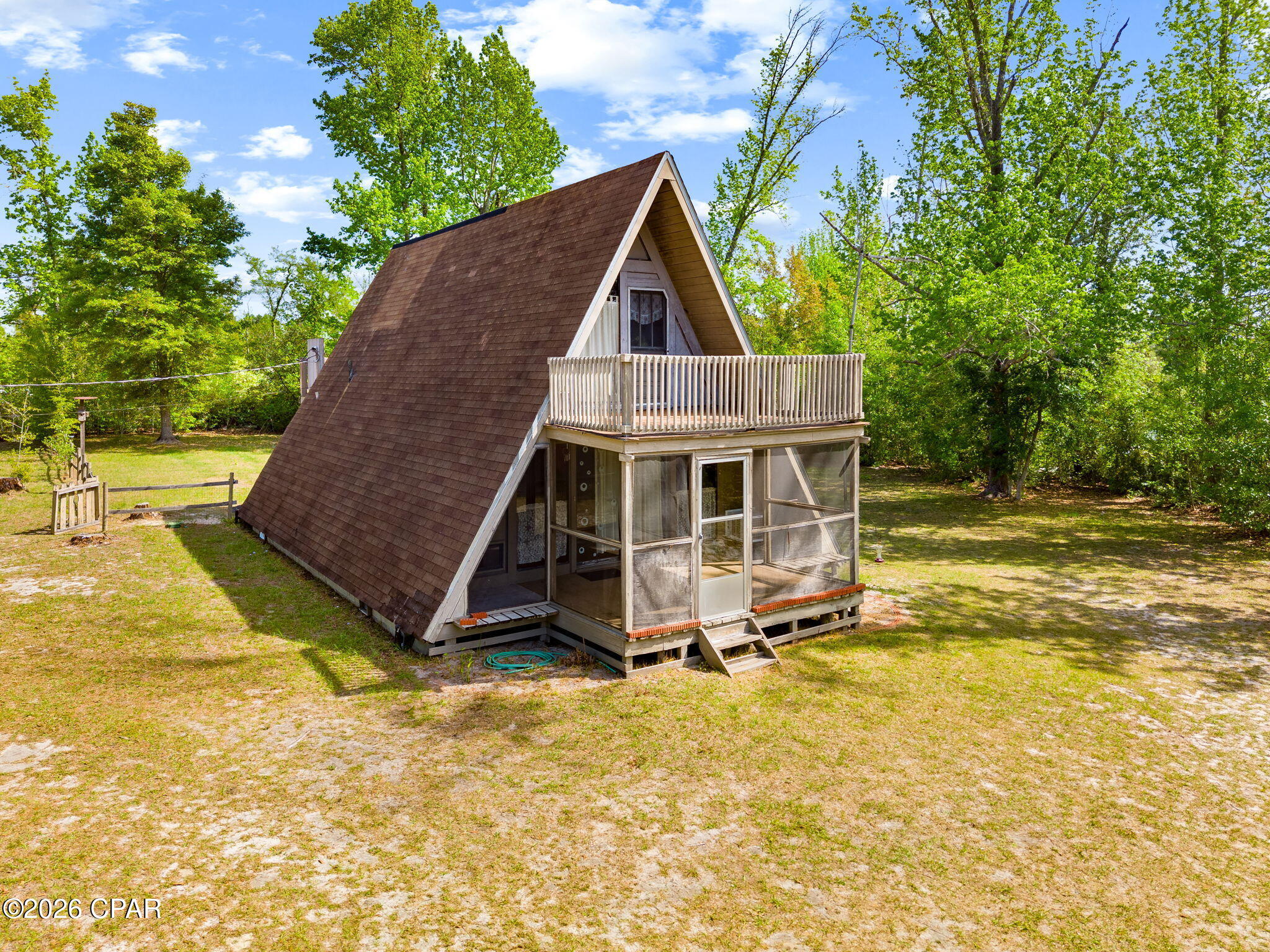 Rare 2.71-acre waterfront development opportunity on Gainer Bayou in Southport, FL. Gated corner lot at Olde Mill Rd & Co. Rd 2321 with direct bayou frontage, fully fenced perimeter, and detached workshop/storage structure. Minimal improvements -- maximum potential. Prime Acreage.