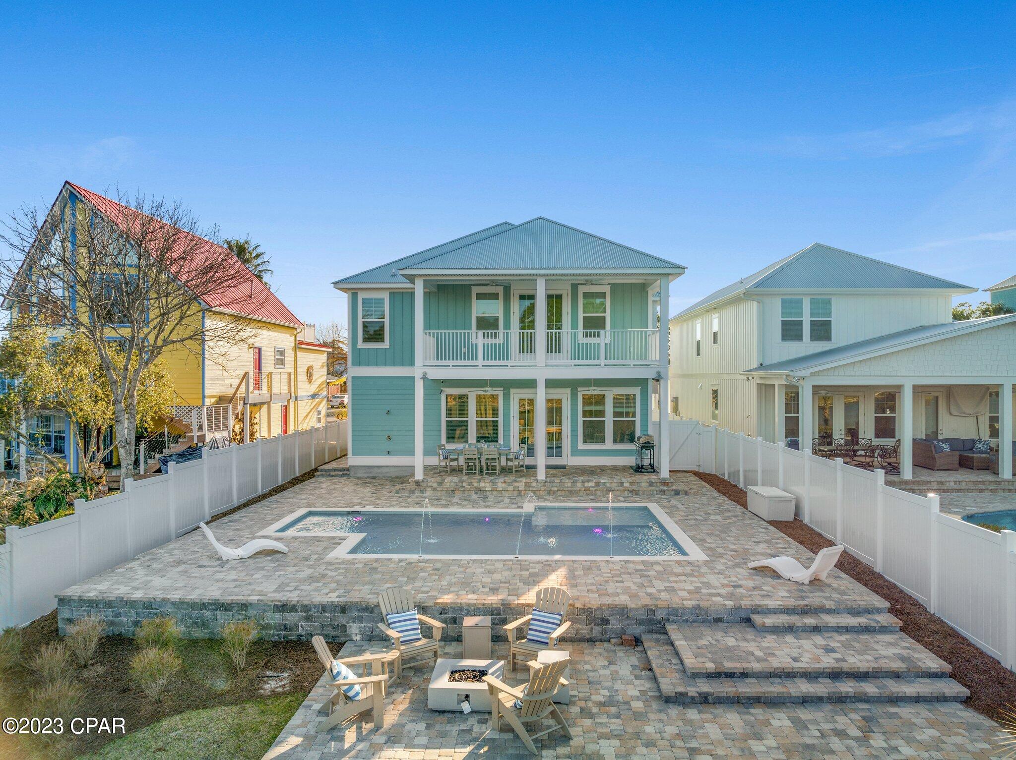 'CURRENTLY UNDER CONTRACT, SELLER WILL CONSIDER BACKUP OFFERS'  Gorgeous Waterfront Home w/ New Deep Water Boat Slip with Trex decking located on Grand Lagoon. Vacation Rental allowed with potential for a turn-key investment or primary. This 5 BR, 4 BA home features two master suites on each level. Heated Pool with sun deck lounge built in, optional multi/solid color illumination for night swims, surrounded by a large paver patio leading to a fire pit area overlooking the lagoon. The chef's kitchen with large island boasts a gas range, stainless appliances and granite. The open concept is perfect for entertaining with spacious living & dining while enjoying the waterfront lifestyle. Upstairs is the main master suite with gorgeous bathroom and waterfront balcony. Two additional bedrooms with shared bathroom, additional bedroom/office, and laundry room. The first floor features the main living space, 2nd master suite and an additional full bathroom with backyard patio access to enjoy freshening up right from that boat or pool day. Security camera system included to keep an eye on things while away on those boat days. Two tankless water heaters; Two HVAC systems; All of the enjoyments of new construction quality locally built with pride. This is a must see home that is perfect for a primary residence or vacation rental investment!
