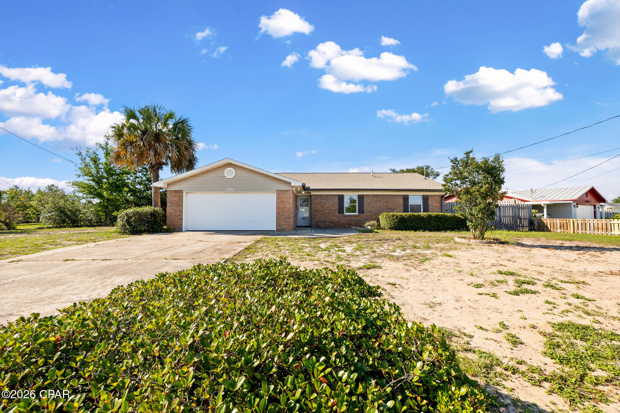 SELLER OFFERING $13,000 IN CONCESSIONS + NO HOA + BAY VIEWS. 

Just minutes from Tyndall Air Force Base, this well-located home offers convenience, flexibility, and coastal charm in a peaceful established neighborhood. Whether you're searching for a primary residence, investment opportunity, first home, or an off-base property near Tyndall AFB, this home provides an excellent opportunity to make it your own. A subtle bay view from the driveway offers a daily reminder of nearby water access, beautiful sunsets, and relaxed coastal living. The spacious corner lot features a fully fenced backyard, providing added privacy and plenty of room for outdoor enjoyment, pets, entertaining, or creating your own private retreat. Take advantage of the double car garage with custom-built workbench and outdoor storage shed. 

Major updates provide peace of mind, including a 2019 roof, 2022 HVAC system, and 2025 gas water heater. Inside, the home features a functional layout with a dedicated dining room, vaulted ceilings, and an electric fireplace adding warmth and character to the living space. The brick foundation offers timeless appeal and a durable construction feature designed for long-term enjoyment.

Located just 1 minute from Under The Oaks Park, Smuggler's Cove Marina, and Gulf Oaks RV Park, outdoor recreation is right at your fingertips. Enjoy walking paths, playgrounds, disc golf, picnic areas, boat ramps, fishing spots, and scenic bay views beneath beautiful historic oak trees. Conveniently located near Callaway's growing shopping and dining options, Historic St. Andrews, revitalized downtown Panama City, and just a short drive to Panama City Beach's world-famous white sand beaches and emerald waters. This home offers the location, flexibility, and lifestyle you've been looking for.