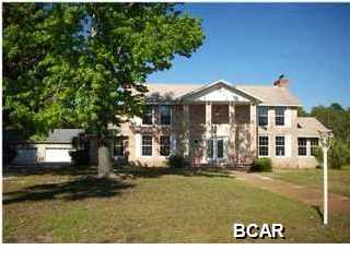 History is the Difference! Glorious Waterfront 2 Story Colonial Home situated on 5 acres of privacy in town with age- old trees, evergreens. Fenced and gated with 2 ponds. Property features an oversized in-ground pool with spa, spacious terraces welcome formal and informal parties and private relaxation. Featuring a sun-fillled interior, molding, Chef's kitchen, large Master Suite with a grand Fireplace for cozy nights. Detached garage and two out buildings. Age and all sizes are estimates only.