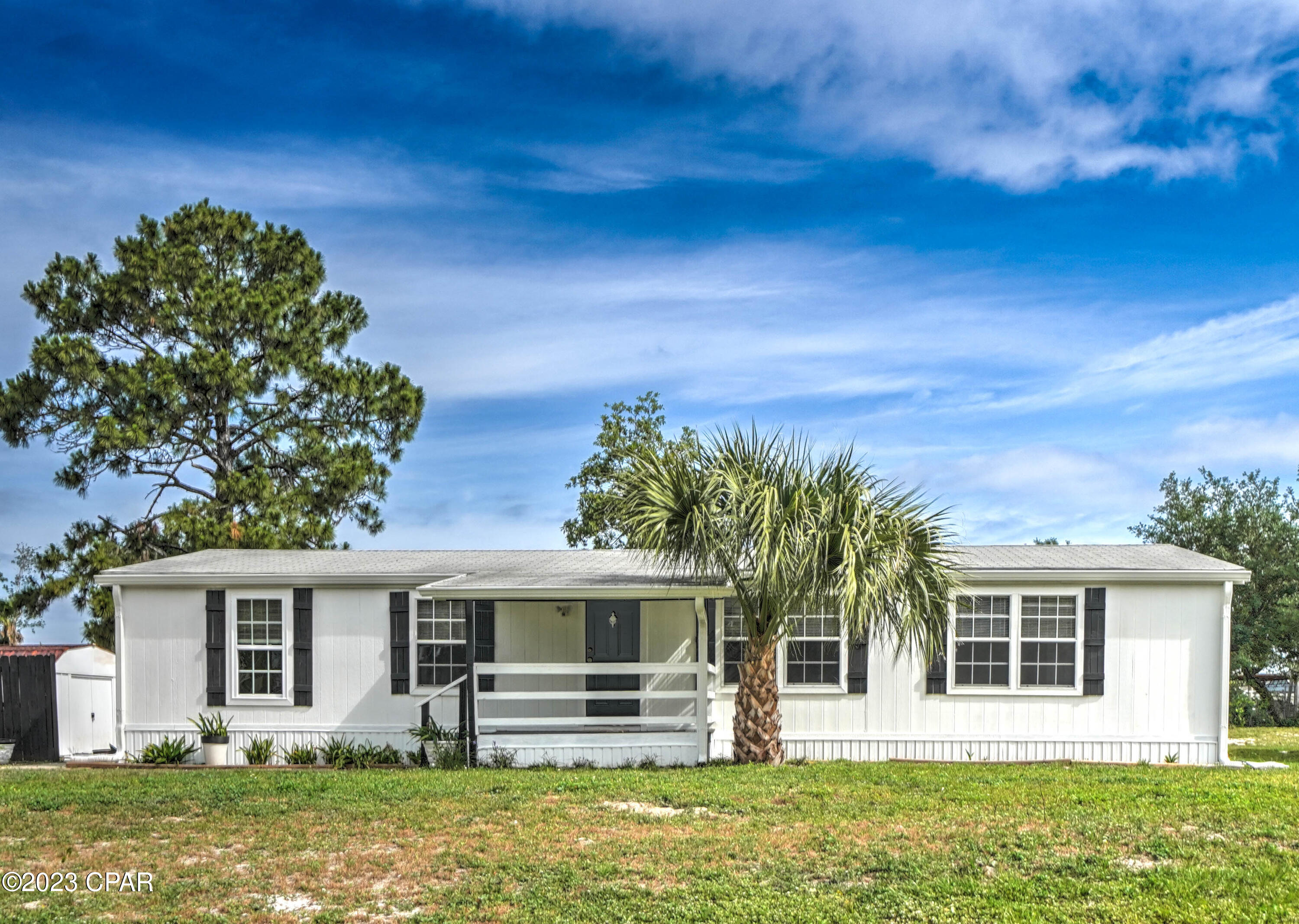 CURRENTLY UNDER CONTRACT, SELLER WILL CONSIDER BACKUP OFFERS    Check out this- 3 bed, 2 bath home with the best location in PCB!  The spacious living room is accented with wood ceiling beams and a cozy fireplace.  The kitchen has a breakfast bar, pantry and is open to living room.   The primary suite has ensuite bathroom and closet and located on the opposite side from the other two bedrooms.  You will love the covered porches on both the front and back of the home... perfect for relaxing after a day on the beach.  The back yard has two sheds on the side and is large enough for whatever recreation you enjoy, an RV, volleyball court, even a pool!  And the Location... well it's simply amazing... Super close to shopping and dining options, St. Andrews State Park and the Gulf. The location is also convenient to Patronis school, Gulf Coast State College, FSU PC & the Navy Base. Come live the good life here on the beach!