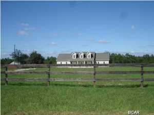 This is an outstanding home built in 2011 on 35 acres of land with a 36 x 36' barn and stables plus a hay barn. This ranch is just 15 miles North of Lynn Haven and convenient to Panama City Beaches International Airport just a few miles from the Bay County - Washington County Line. The home features an open kitchen with stainless steel Maytag appliances, granite counters,great room and fireplace. In addition to the four large bedrooms, there is a 11 x 8 office. The layout is a split bedroom plan. There simply isn't anything on the market that compares! Realtors - Easy access via lockbox or call for a viewing!