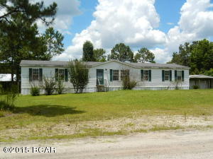 Terrific doublewide on a little more than 1/2 acre offers a super nice layout that includes an ''L'' shaped living/dining area, split-planned master suite w/sitting room, master bath/spa w/dual sinks and garden tub, and dual walk-in dressing closet, beautiful kitchen w/all built-in appliances, prep island/breakfast bar, and utility mudroom w/washer & dryer, family room w/corner stone fireplace, and 3 additional bedrooms w/reach-in closets.  Pretty molding is featured throughout the home! Great location in between Youngstown and Lynn Haven. EQUAL HOUSING OPPORTUNITY.