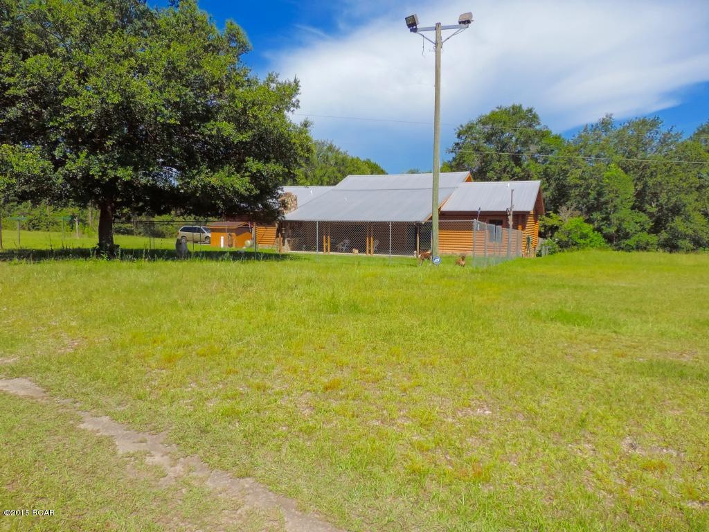 Rare, Log Cabin located on 11.5 acres on 418' of water front on the Dead Lakes. Home has a pool with new liner & pump, and a large deck over looking the views. Home has a new metal roof, and the three sliding glass doors onto patio have been replaced. Kitchen has been updated with solid surface counter tops and newer appliances. grand great room with a large fireplace, open beamed ceilings that are very rustic.  Split floor plan with a large master bath ensuite.  You have access to the Apalachicola River and Bay. Also, there is a private fishing pond, this is a outdoorsy persons dream come true.  Do not miss out on this rare opportunity to own your own private Log cabin retreat! All sizes and SQFT is approximate if important please verify.