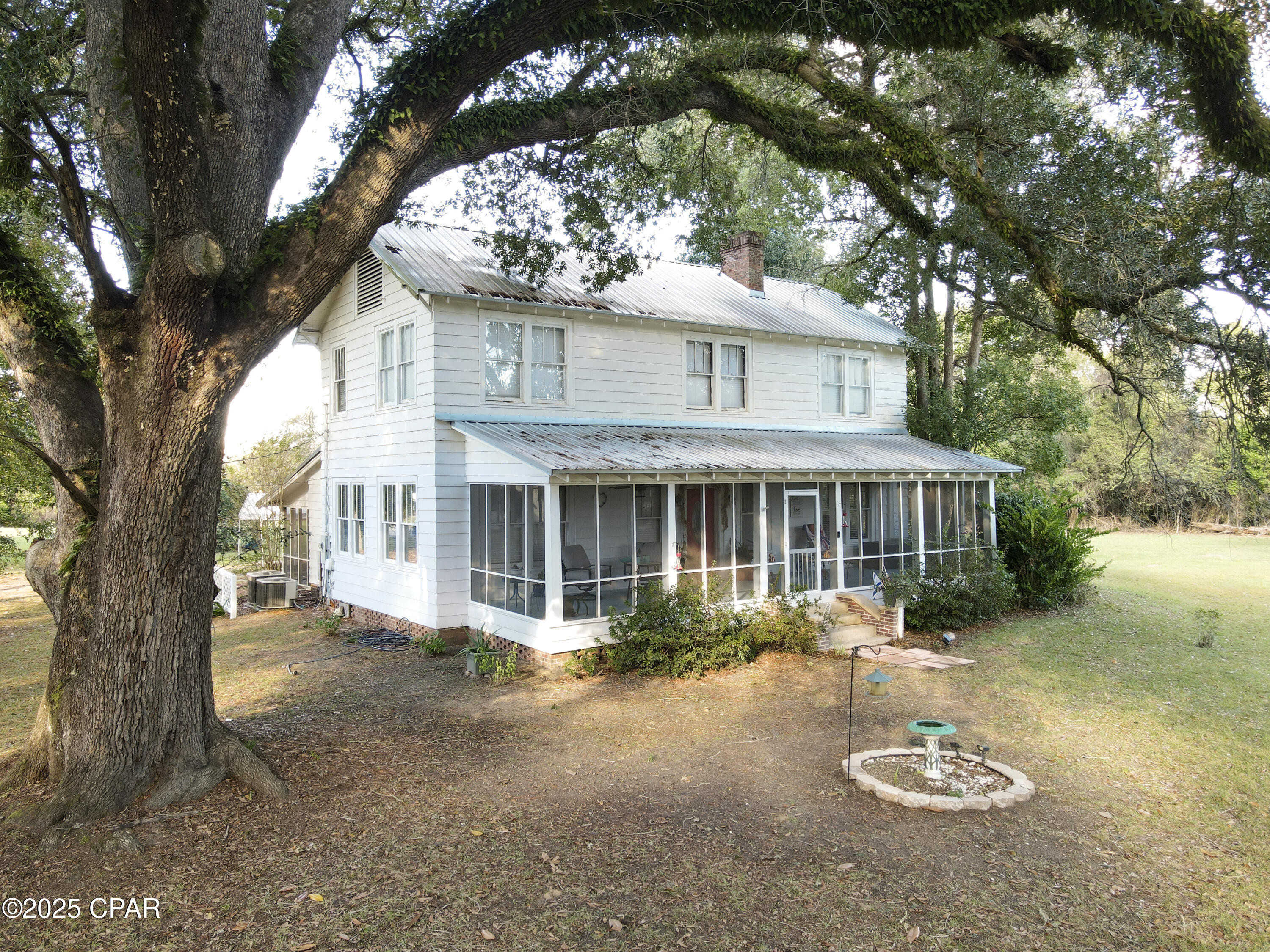 This 4 bedroom 2 bath historic home, built in 1945 in Greenwood, Florida has been lovingly maintained for all 8 decades of its life.  Charm abounds inside and out.  The  home shares the 2.6 acre lot with majestic mature oaks that make lounging on either of the two large screened porches seem like a scene from a southern love novel.   Inside awaits 2248 square feet of living space boasting beautiful original hardwood floors and molding, cedar-lined closets, and solid wood 5 panel doors with original antique hardware.  The primary bedroom and one bathroom are conveniently situated on the main floor while the other three bedrooms and one bathroom are located upstairs. The local grocery store is just 0.2 miles away and the Marianna schools and recreation facilities are about a five mile drive away.  This kind of home is rarely up for grabs!  Don't miss out!  Book a tour today!