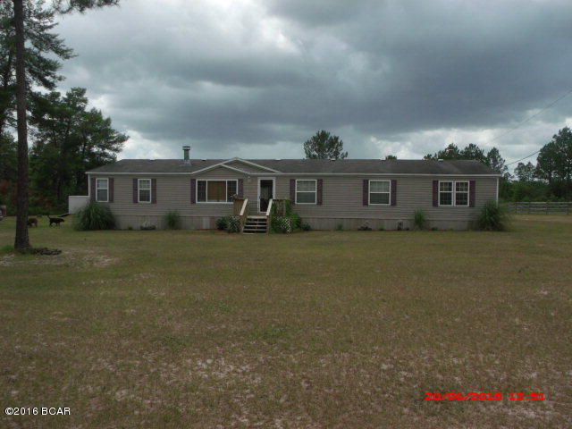BEAUTIFUL Double Wide 4 bedroom/2 bath, well maintained mobile home on 20 acres. This property affords privacy, hunting, and a place for your horses! Inside features a split floor plan with a den area (or 4th bedroom) and two bedrooms at one end and master bedroom and master bath at the other. In between is the living room with a fireplace, kitchen with an island, and a separate dining area. Exterior features are a large deck across the back, porch on front, fire-pit area, pole barn, fencing for horse pasture, a round pen, and a storage building. This is a very nice, quiet and peaceful place. Please make an appointment to see this one!