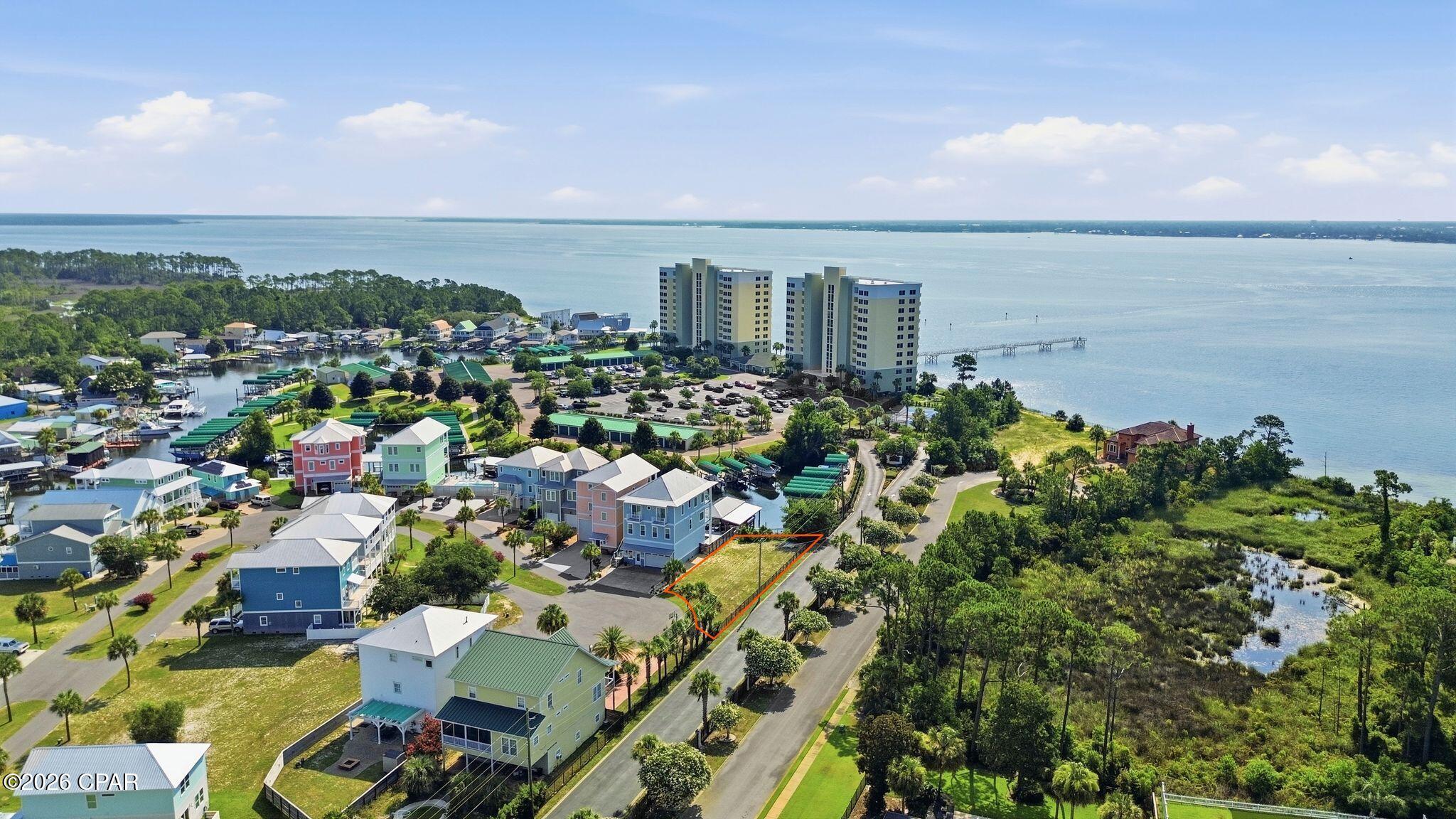 Coming soon - No Showings! Motivated Seller! Build your dream home on this prime cul-de-sac waterfront lot in the gated community of Harbour Cove Village along Millionaire's Row. This ready-to-build homesite offers added privacy and extra space with its unobstructed bay views and corner lot location, making it one of the community's most attractive lots.

Enjoy direct canal frontage with convenient bay access, perfect for keeping your boat, jet ski, kayak, or paddleboard just steps from your future home. Spend your days exploring the bay or heading out to the Gulf with ease.

To help bring your vision to life, the seller is including floor plans specifically designed for this lot, offering a valuable head start on the building process.

Ideally located less than 10 minutes from the nearest beach access and minutes away from fine dining plus local shops, this property combines waterfront living with exceptional convenience. Whether you're building a primary residence, vacation getaway, or investment property, this is an incredible opportunity to own one of Harbour Cove Village's premier homesites.
