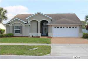 Don't miss your opportunity to own the best priced pool home in Summerwood! This beautiful 4 bedroom, 2.5 bath home has tiled flooring throughout the main areas. The living room has high ceilings and is open to the kitchen. The kitchen features a breakfast bar, solid surface countertops, and white appliances. The master bedroom has his and hers walk in closets and overlooks the GORGEOUS inground swimming pool. Master bath has a double vanity, tub/shower combo, and a water closet. This a split bedroom floorplan with 3 bedrooms that share a full bath and a 1/2 bath. There is a huge inground swimming pool with a waterfall, pavered deck, and a pirate themed pool house! This neighborhood is located close to Pier Park and the world's most beautiful beaches. Schedule your viewing today!!!