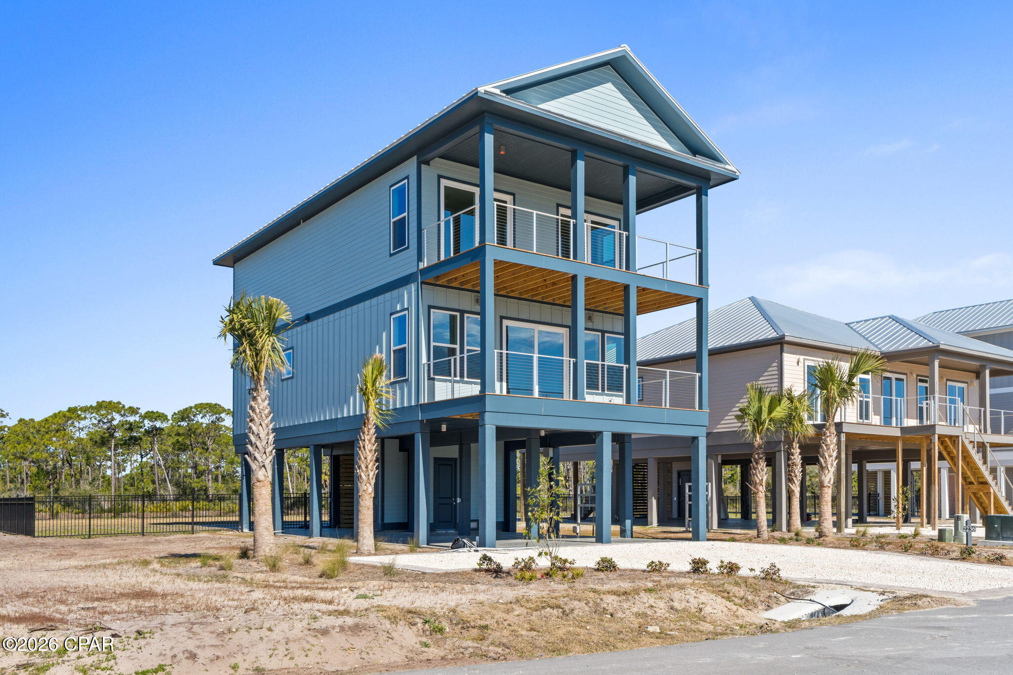 Relaxed coastal living reaches a new level at this beautifully designed home in Heron's Crossing, a premier enclave within Casa Del Mar at The Plantation on St. George Island. Perfectly positioned to capture tranquil water views, this 4-bedroom, 4-bath residence offers 2,344 square feet of thoughtfully crafted living space that blends comfort, style, and the effortless rhythm of island life. Designed for both gathering and unwinding, the open-concept layout is filled with natural light and showcases high-end finishes throughout, including designer cabinetry, premium countertops, and a chef-inspired kitchen complete with a professional-grade range, custom vent hood, and stainless steel appliances. Wide-plank flooring, elevated trim details, and a clean coastal palette create a refined yet relaxed atmosphere that feels both sophisticated and inviting. The living spaces flow seamlessly to outdoor areas where coastal breezes and water views take center stage. Step outside to your private inground pool, perfect for sun-soaked afternoons and laid-back evenings under the stars. Each bedroom offers space and privacy, making this home ideal for full-time living, a vacation retreat, or a high-performing rental. From morning coffee overlooking the water to evenings spent enjoying coastal sunsets, every detail is designed to enhance the lifestyle. Located within the gated Plantation community on St. George Island, residents enjoy access to pristine beaches, nature trails, and a peaceful, unspoiled coastal setting. Spend your days biking, boating, fishing, or simply relaxing in one of Florida's most sought-after coastal destinations. This is more than a home--it's a lifestyle defined by luxury, comfort, and the freedom to truly Live the Beach Life.
