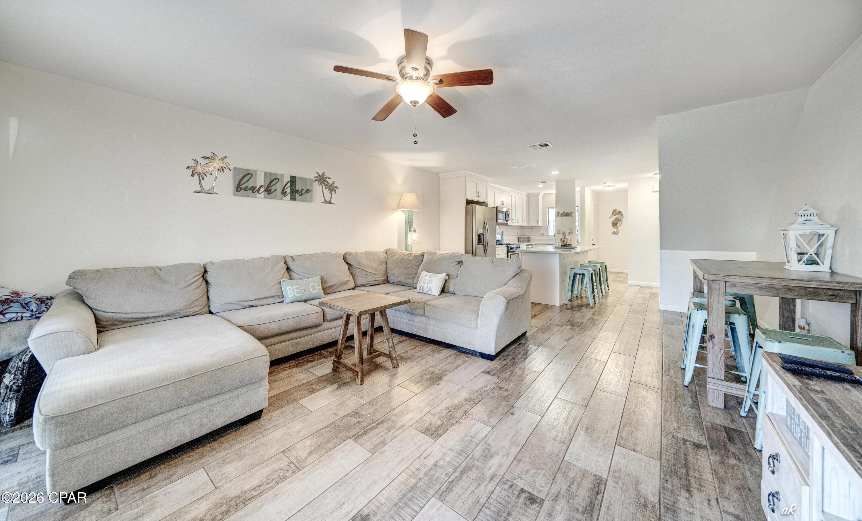 This updated home is one of few open floor plans in Beachwalk.  In 2018 it was beautifully and professionally updated with solid surface countertops, new cabinets, ceramic flooring downstairs, LVP throughout the rest of the home, new paint, tiled showers, sinks, toilets and more.  This home features 2 baths, but also has a separate vanity/sink off the master. SHORT TERM RENTALS ARE ALLOWED.  TASTEFULLY FURNISHED and equipped with WIFI thermostat and electronic door lock, makes this property turnkey, while managing the property yourself a breeze, if using it as a rental.  It has been primarily used as a second residence and is in EXCELLENT CONDITION.  This is also one of the few homes in the quiet neighborhood of Beachwalk with the main entrance positioned thru the living area versus kitchen/bath hallway. Conveniently located steps from the pool or a short 7 minute walk to the beach enables you to enjoy the beautiful Florida weather with ease.  New roof in 2025, newer appliances, and very recently replaced exterior gas lines alleviates the worry of those expenses. THIS HOME IS MOVE IN READY and, while more updated than the other homes on the market, it is also competitively priced!  Book your showing today!