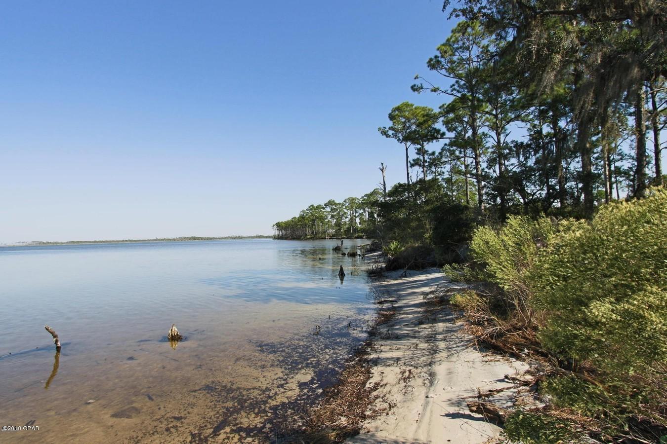 124 Acres on West Bay in Panama City Beach - ''The Oak Grove on West Bay''.  Located on the east-side of Colony Club & Trieste neighborhoods & the Legacy Golf Club (f/k/a Holiday Golf Course).  Over 1,200 feet of waterfrontage on West Bay with expansive views across the Bay. It is comprised of 3 parcels; A=59.9 Acres on West Bay, B=60.1 Acre interior parcel and C=4.4 Acre parcel on West Bay and accessed via Moonlight Bay Drive.  The sellers will not subdivide. The primary access is via the Clara Avenue extension, which is a 100' right of way, now paved close to the south property line. The site has been annexed into the City of Panama City Beach & zoned P.U.D. & Conservation.  The highest-and-best use is residential &/or resort.  Conceptual site plans, wetlands delineation, surveys and maps are attached.  Call for detailed information & to setup a tour.
