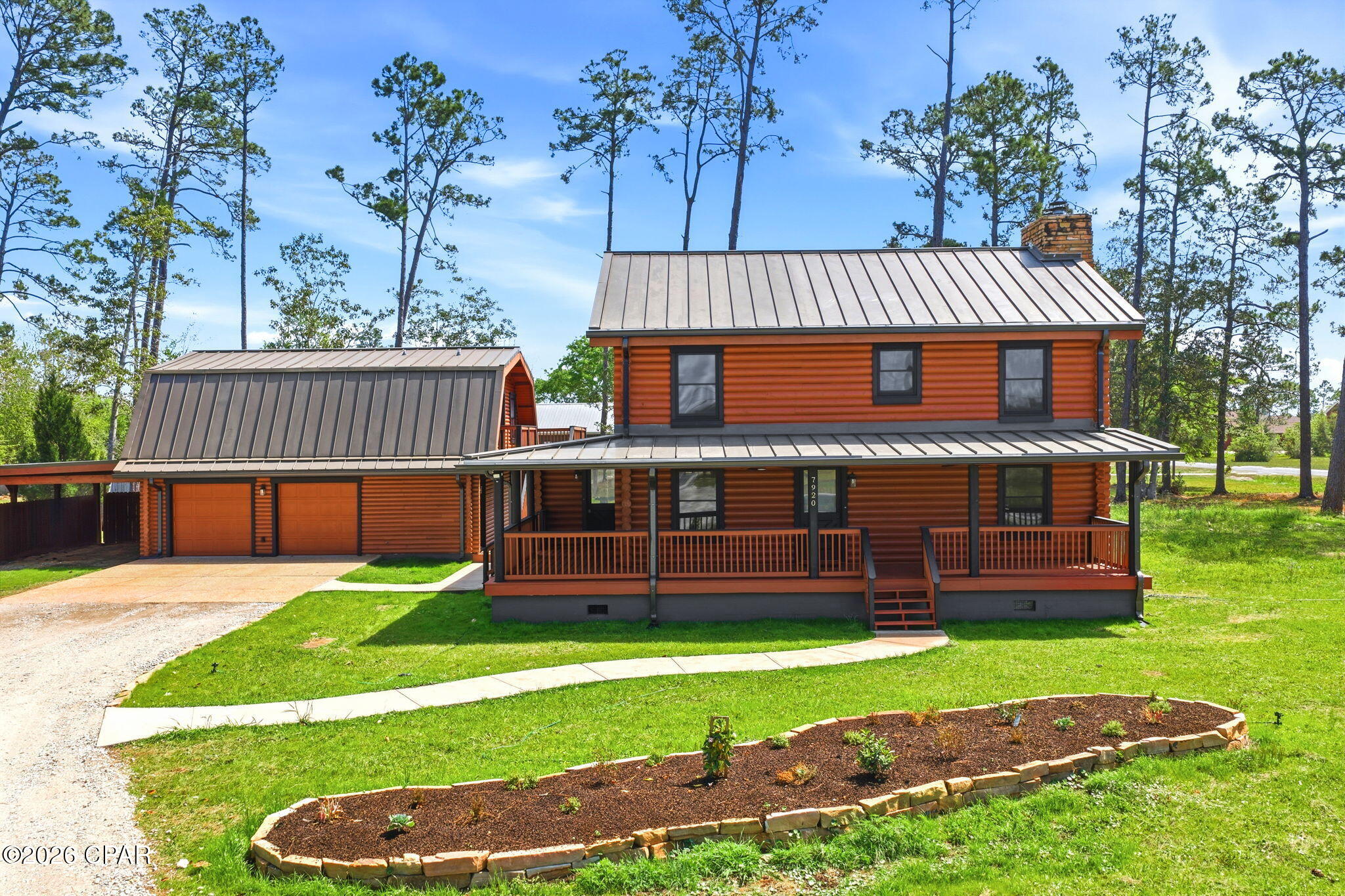 Rare opportunity to own a true log cabin situated on two private acres while still being conveniently located near everyday essentials. The horseshoe driveway with dual entrances adds both convenience and curb appeal, and the property is ideally positioned close to schools, Deerpoint Lake, nearby boat ramps, the beaches, and all your daily activities.

This property offers exceptional versatility with a large detached garage/workshop fully equipped with electricity, perfect for hobbies, storage, or business use. An added bonus is the detached efficiency apartment/suite, complete with a full kitchen, full bathroom, and spacious living area--ideal for guests, extended family, or potential rental income.

Inside the two-story home, you'll find a spacious, updated kitchen featuring granite countertops, new cabinetry, and stainless steel appliances that flow seamlessly into the formal dining room. The large great room showcases a cozy fireplace, creating a warm and inviting atmosphere, along with an updated half bath conveniently located on the first floor.

Upstairs, the primary suite offers a private retreat, complete with its own fireplace for relaxing evenings, a private en-suite bathroom, separate makeup vanity, and recessed ceilings. Two additional bedrooms also feature recessed ceilings, along with the convenience of a large attic space with dedicated access for additional storage.

Outdoor living is just as impressive. You'll love the covered front porch that wraps nearly all the way around the home, along with a spacious back deck overlooking the fully fenced backyard. The fire pit area creates the perfect setting for gatherings, entertaining, and enjoying peaceful country evenings.

Additional highlights include a New HVAC system. New hot water heater, Freshly stained log exterior, New roof (2022), Beautifully updated landscaping, Fully fenced privacy yard

With its unique character, functional layout, income potential, and acreage, this property truly combines the charm of country living with the convenience of being close to everything.