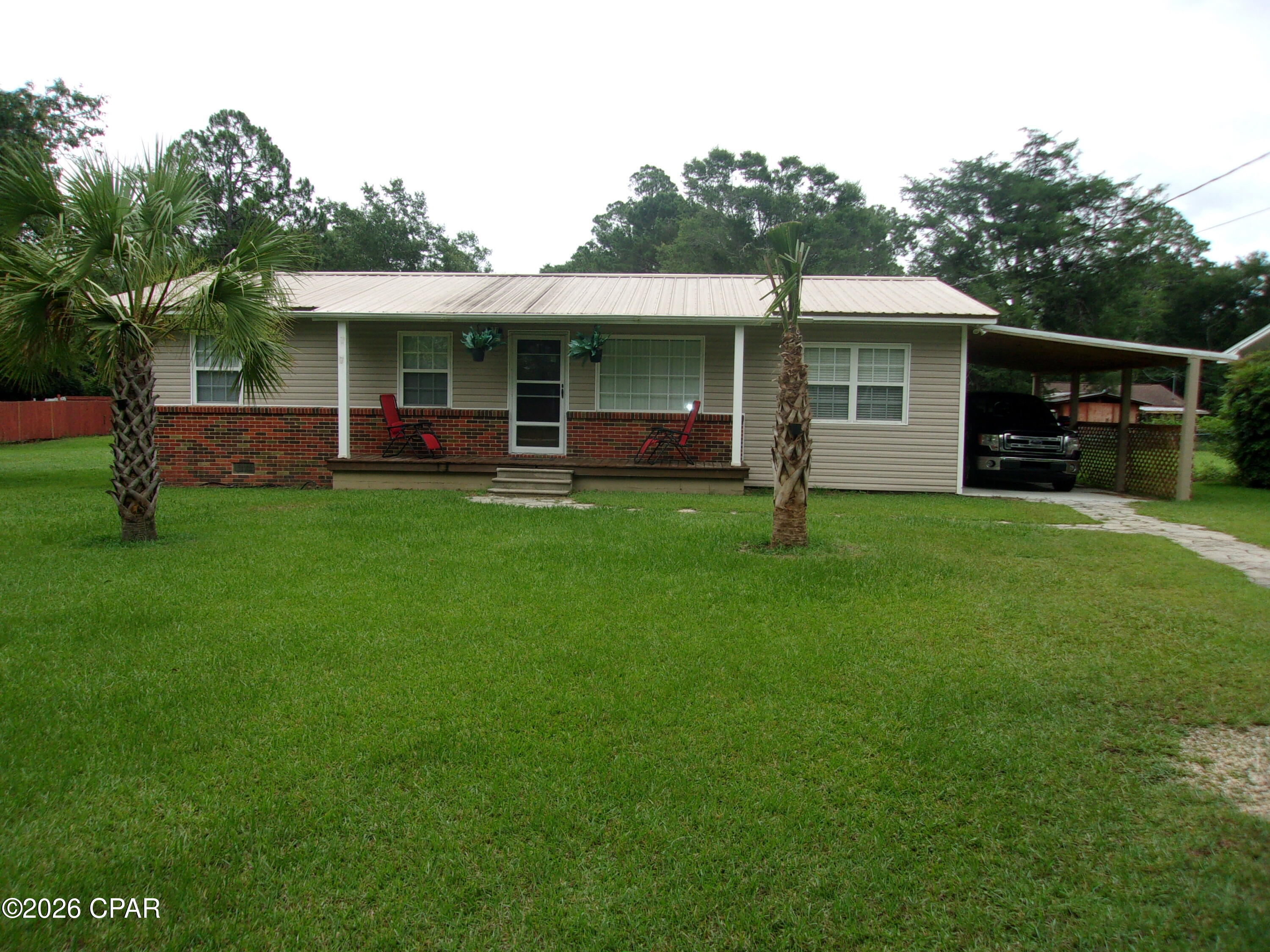 Charming and exceptionally well-maintained 3-bedroom, 2-bath brick and vinyl home situated on a beautiful 1-acre lot within the city limits of Chipley, Florida. This move-in-ready property features a cozy kitchen with a large eat-at bar, recessed lighting, and an inviting floor plan designed for comfortable living. Step outside to enjoy the spacious patio deck and fire pit, perfect for entertaining family and friends. The property also includes a 24' x 36' pole barn with water and electricity, an attached one-car carport, upgraded windows, and attractive palm trees that enhance the home's curb appeal. Enjoy peace of mind year-round with a Generac whole-house generator, ensuring power is always available. As an added bonus, the washer, dryer, and riding lawn mower will convey with the sale. Conveniently located just one hour from Panama City, Florida, and the stunning Gulf Coast, you'll have easy access to some of the world's most beautiful beaches while enjoying the comfort and convenience of small-town living.