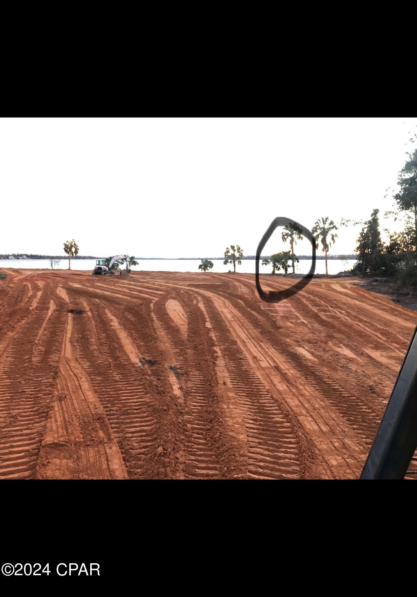 Nothing improves a beautiful view more than a NICE PRICE REDUCTION, right? Well, how about some OWNER FINANCING, too?? With a minimal down payment this beautiful lot could be yours!
Why not go by and take a look at this property and see if it will work for you. YOU WON'T REGRET it! 
The whole Bay Head peninsula is looking straight down Deer Point Lake. There is over 300' of water frontage. This is a very large estate size lot for the person who wants a lot of space and privacy. There is an Artesian Well on the property. The road easement on the lot totals 1.45 acres. The lot is big enough to  build most any size home your buyer wishes to build along with a big shop, guest house and pool. No Seawall is required.