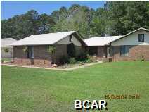 Absolutely stunning, all brick, recently upgraded and renovated EXECUTIVE home on spacious manicured lot in Panama City. 90 seconds is all it will take you to realize you have stepped into your next home. Every where you look you will see quality. This home has never been a rental and has been immaculately maintained and cared for. The kitchen is gorgeous. Light Maple cabinets, Stainless Steel Appliances, Plank ''wood look'' ceramic tile flooring throughout, and fabulous granite counter tops. Movable Island doubles as a breakfast bar or extra baking space. The only place you find carpet is in the bedrooms. The Great room is very open and spacious with a brick wood burning fireplace and plenty of space to accommodate large parties or a comfortable evening in front of the fireplace. This