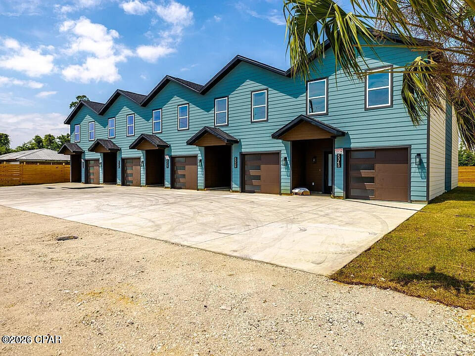 ADDITIONAL UNITS AVAILABLE!
Welcome to luxury living just minutes from Tyndall Air Force Base! These beautifully crafted townhomes offer the perfect combination of quality construction, modern finishes, and everyday convenience--with no HOA fees and no restrictive covenants.

Built with durable 2x6 exterior wall construction for enhanced energy efficiency and long-term value, these homes stand apart from typical new construction. The thoughtfully designed open-concept floor plan creates an inviting space for entertaining and daily living, seamlessly connecting the living room, dining area, and kitchen.

The stylish kitchen features butcher block countertops, white shaker-style cabinetry, soft-close drawers, stainless steel GE appliances, and ample workspace for cooking and gathering. Luxury vinyl plank flooring throughout the main level adds both elegance and durability.

Upstairs, the spacious primary suite offers a private retreat with a beautifully tiled walk-in shower, dual vessel sinks, and designer finishes. Additional bedrooms provide comfortable accommodations, while the convenient second-floor laundry room adds everyday functionality.

The insulated, heated, and cooled garage offers incredible flexibility--perfect for a home gym, workshop, office, hobby space, or climate-controlled storage. Additional upgrades include R-19 insulated interior walls for enhanced sound reduction and energy efficiency.

Outdoor living is equally impressive with a welcoming covered front porch and a private rear patio ideal for grilling, relaxing, or entertaining guests. As an end unit, this home enjoys additional yard space and the freedom to add fencing or customize the outdoor area to fit your lifestyle.

Conveniently located near shopping, restaurants, fitness centers, local bayous, and the waters of St. Andrews Bay, this exceptional property delivers the perfect balance of comfort, quality, and location. Whether you're looking for a primary residence, military relocation, or investment opportunity, this is a home you'll want to see.