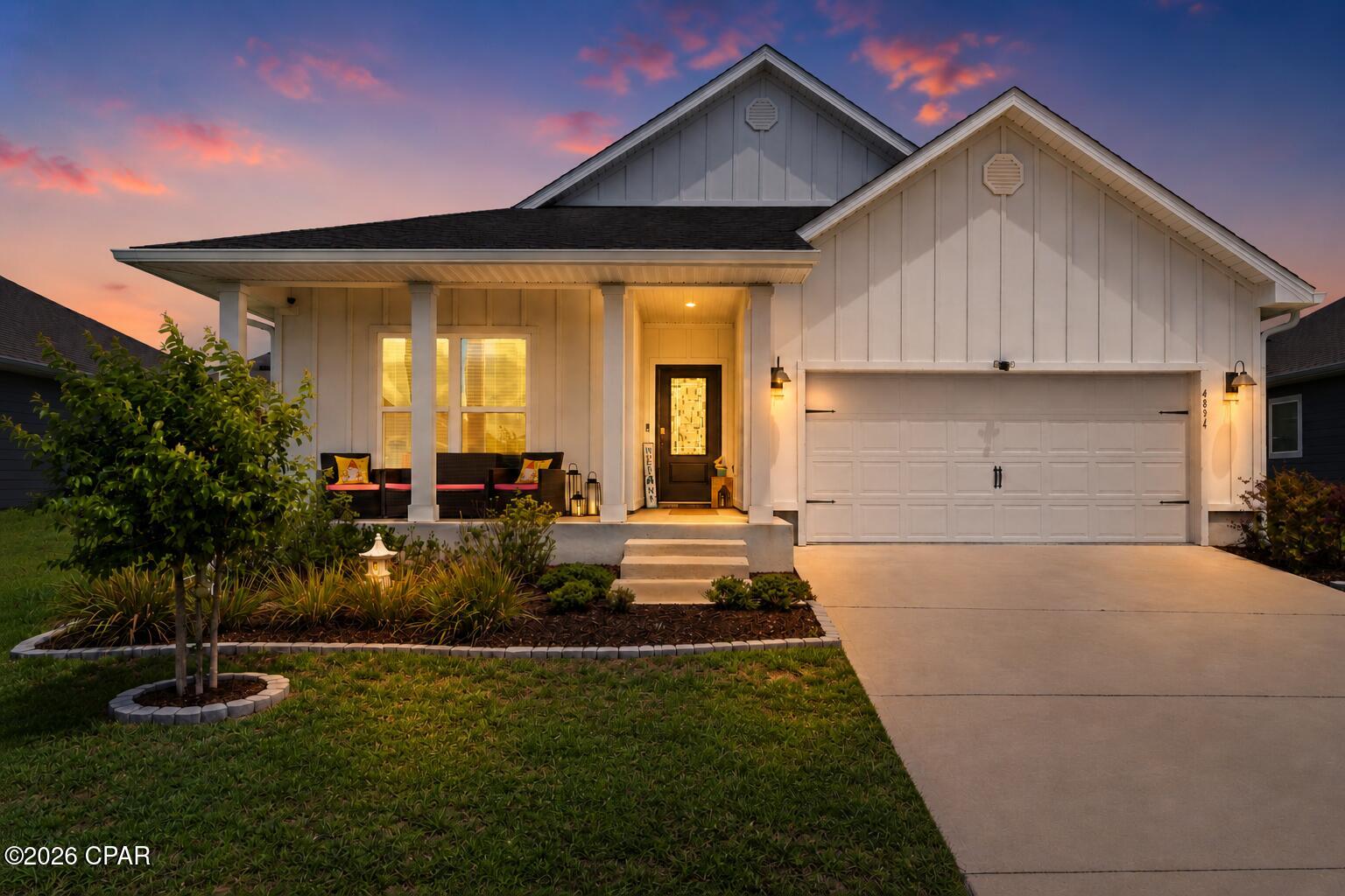 Beautifully designed Delray floor plan located in the desirable Titus Park community! Offering 4 bedrooms, 2 bathrooms, and over 2,000 square feet of thoughtfully designed living space, this 2023-built home combines functionality, comfort, and style in one of the area's most convenient locations.

Enjoy a charming covered front porch, Hardie board siding, and a beautifully landscaped sidewalk-lined community featuring a community pool and convenient access to Publix, North Bay Haven Charter Academy, and the Hwy 231 corridor for an easy commute throughout town.

Inside, the home features a bright open-concept layout with tall ceilings and a spacious living, dining, and kitchen area designed for everyday living and entertaining. The kitchen offers white cabinetry, a large center island, ample countertop space, and abundant storage.

The split bedroom floor plan provides added privacy, with the primary suite tucked away at the back of the home. The spacious primary bathroom includes dual vanities, oversized countertop space, two separate closets, a water closet, and a large 5-foot shower.

Near the front of the home, the flexible fourth bedroom located beside the oversized laundry room can easily function as a home office, flex space, or guest room depending on your needs. The laundry room itself offers additional storage space and functionality.

Step outside to enjoy one of the home's standout features, a large screened and covered back porch overlooking the fully fenced backyard, creating the perfect space to relax and enjoy Florida living year-round.