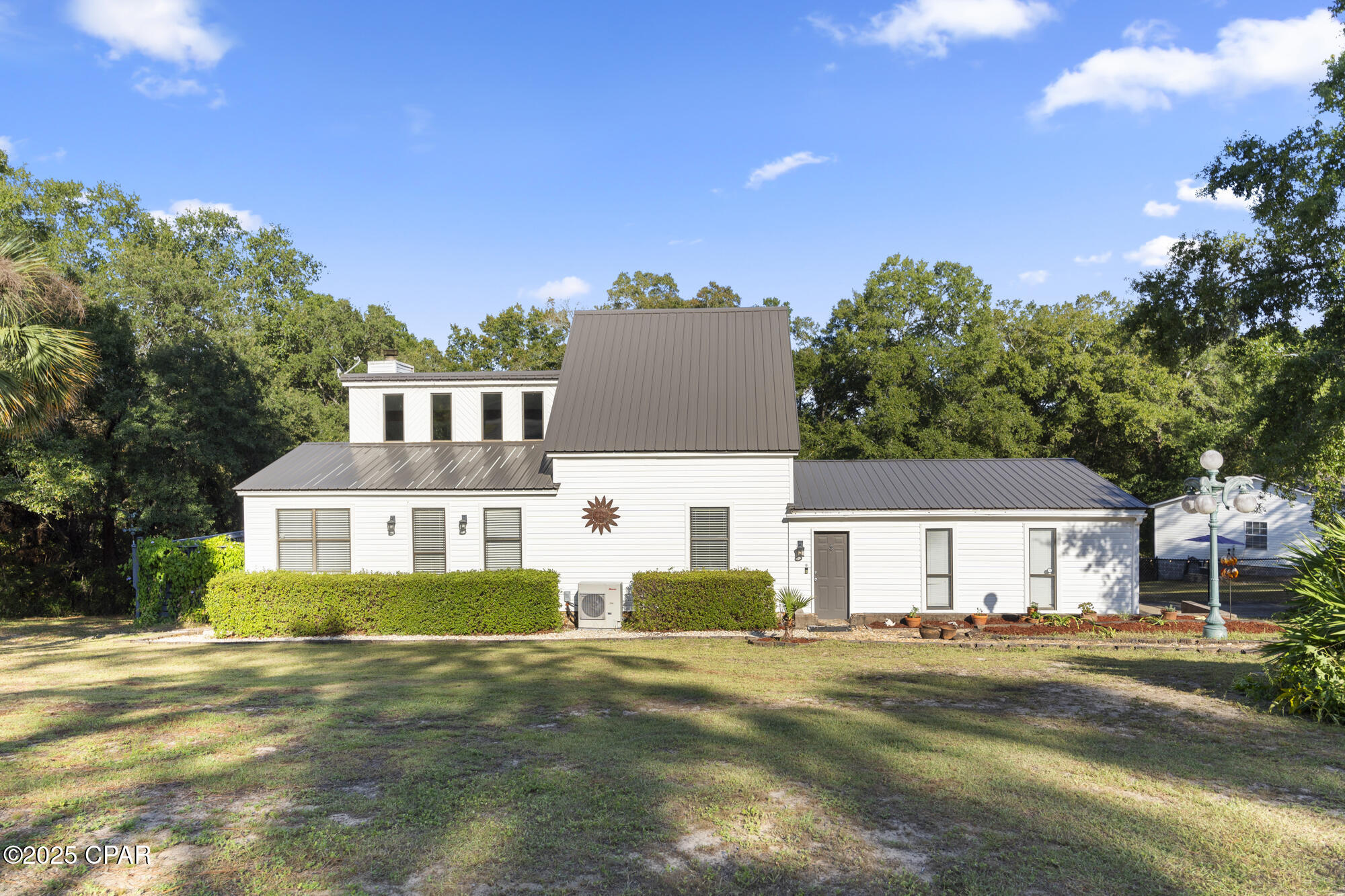 Lakefront living with room to breathe on beautiful Payne Lake! Situated on 1.45 private acres just outside Chipley, this property offers peaceful country living with easy access to Panama City, the Gulf Coast, and Tyndall Air Force Base.
Inside, the open-concept layout is filled with natural light and showcases stunning lake views through expansive windows. The spacious kitchen flows seamlessly into the living and dining areas, creating the perfect setup for entertaining or relaxing after a day on the water.
Step outside to a large deck shaded by mature oak trees overlooking the lake--ideal for morning coffee, sunset dinners, and weekend gatherings. Enjoy kayaking, fishing, paddleboarding, and abundant wildlife right from your backyard.
A separate efficiency suite with private entrance, kitchenette, and full bath adds incredible flexibility for guests, multi-generational living, or potential rental income. With no HOA and plenty of space for boats, hobbies, gardens, or future expansion, this property offers the freedom to truly enjoy lake life.
All this while being less than an hour from Panama City and the beaches. If you've been searching for privacy, views, and a laid-back waterfront lifestyle, this Payne Lake retreat delivers.