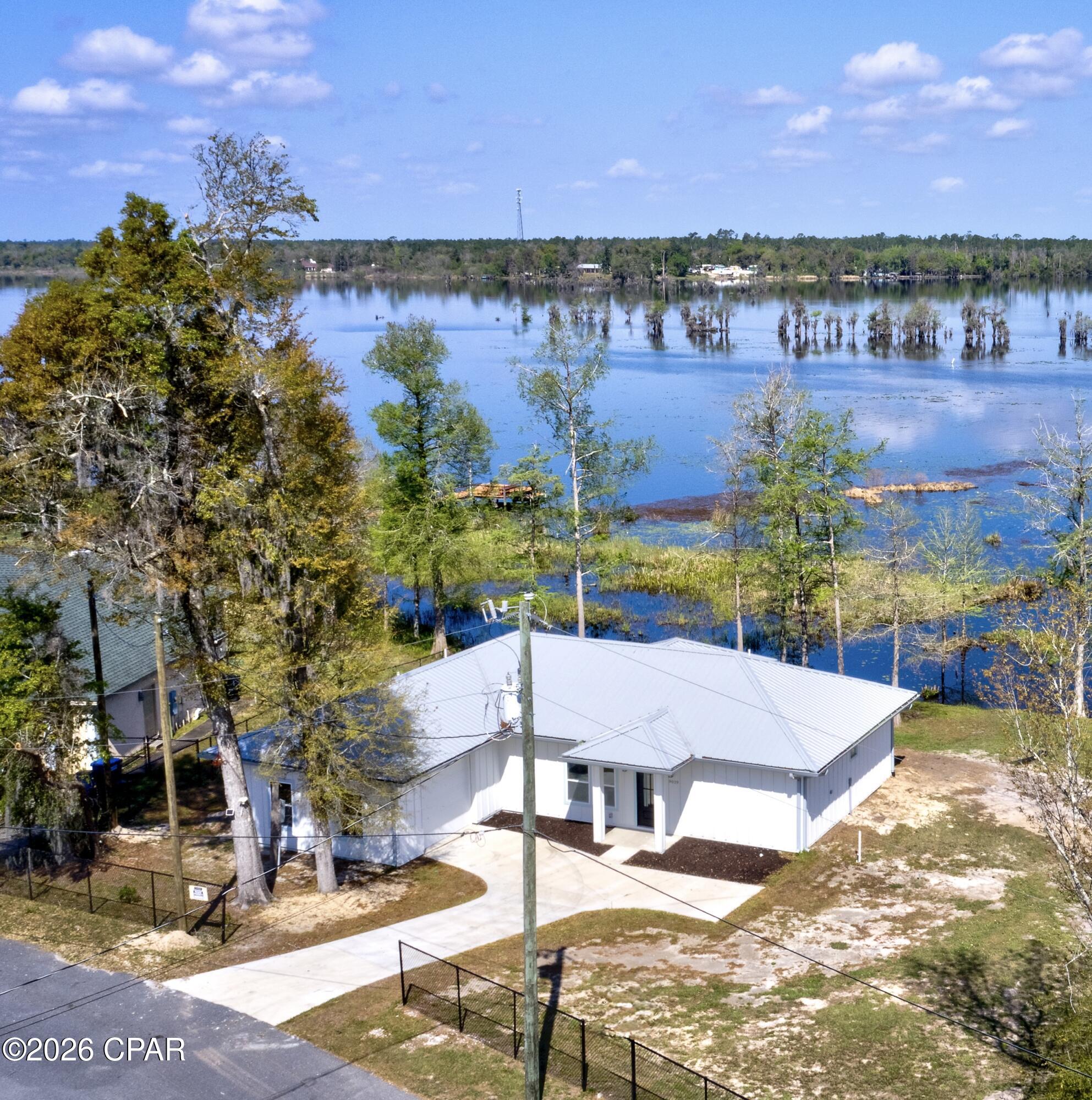 Experience the ultimate Deer Point Lake lifestyle in this stunning new-construction waterfront retreat. Located in the Lakeshore Heights community of Youngstown (near Southport), this modern home perfectly blends luxury design with peaceful lakeside living.

The open-concept floor plan is bathed in natural light, featuring breathtaking lake views from the kitchen, living room, and primary suite. The gourmet kitchen is an entertainer's dream, complete with premium granite countertops and a layout designed for seamless flow. With two spacious bedrooms, three full bathrooms, and a versatile flex room--perfect for a home office, gym, or guest suite--the home adapts to any lifestyle.

Outdoor highlights include a private dock for direct lake access--ideal for boating and fishing--and a two-car garage. Situated approximately three feet above the flood zone for added peace of mind, this home offers both beauty and resilience. You're just minutes from three public boat landings, including the popular Cherokee Landing.

Don't miss this rare opportunity to own a brand-new lakefront home on Deer Point Lake. Schedule your private showing today!