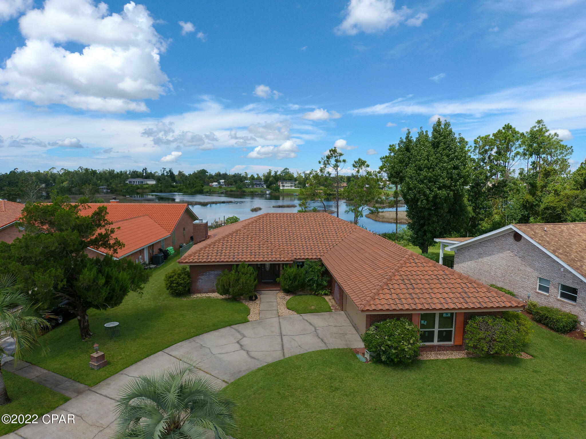 Price adjusted for current market. Fantastic opportunity to own this beautifully landscaped well cared for waterfront home located on Callaway Bayou. Solid brick home with a new Southwest/ Mediterranean-inspired tile roof that will last a lifetime. As soon as you enter the front door you will be wowed by the beautiful open living room with a view of the bayou. Freshly painted interior with neutral colors that will match any home décor. Large master bedroom that opens into a large screen porch on one side and a spa like bathroom on the other. New vinyl plank flooring and carpet in several rooms. Enjoy your morning coffee or evenings winding down relaxing in your screened porch overlooking the beautiful water. Energy efficient home with all new sandstone color high impact windows, French door and newer high efficiency air conditioner. Unique wet bar just off the living room great for those family get togethers and parties. Large fenced back yard that leads out to dock and bayou. Quiet much sought after neighborhood that's close to Tyndall Air Force Base, parks, schools, restaurants, and shopping. All measurements are approximate, please verify if important. Call your favorite Realtor for a showing today!